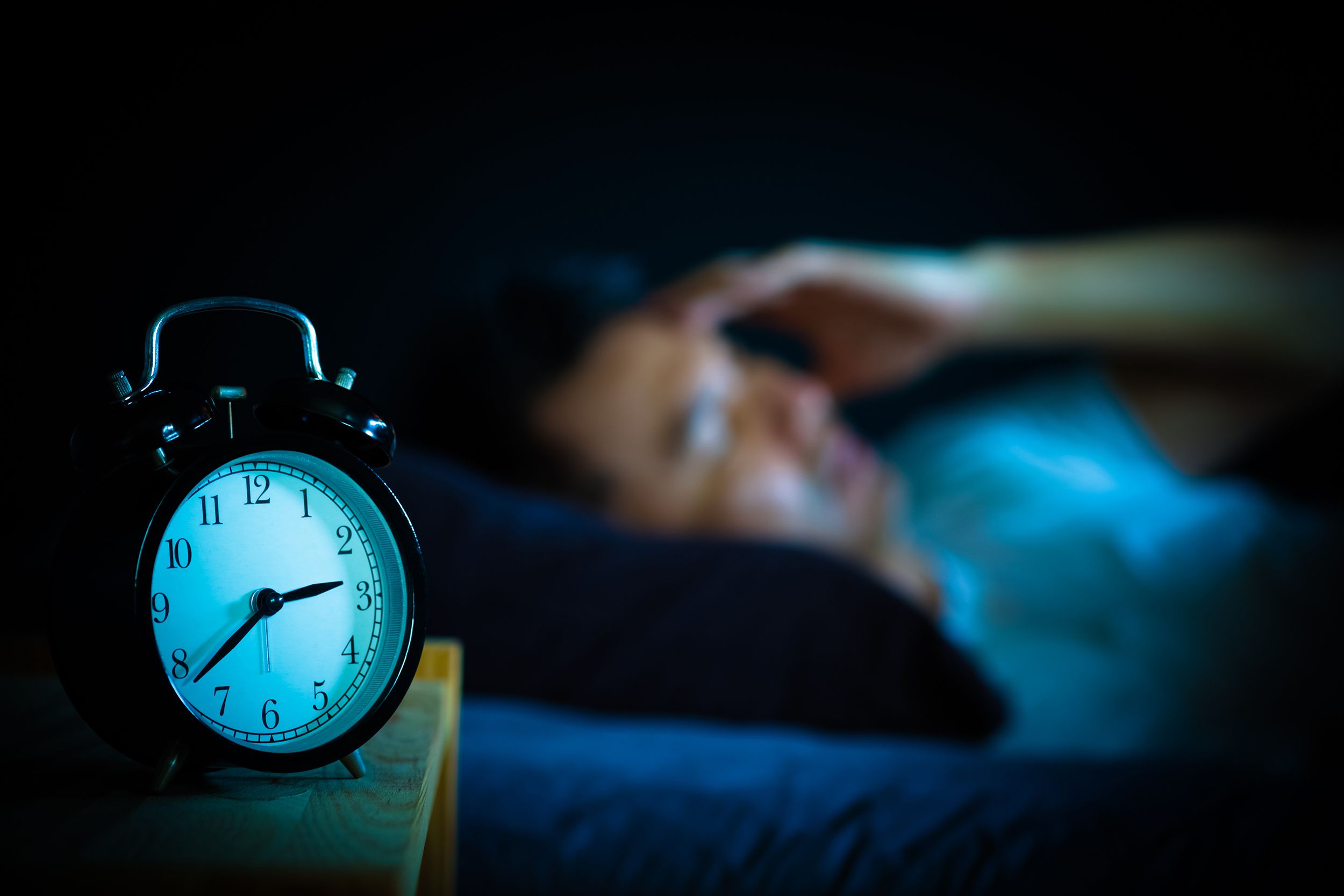 Asian man in bed suffering insomnia in bed
