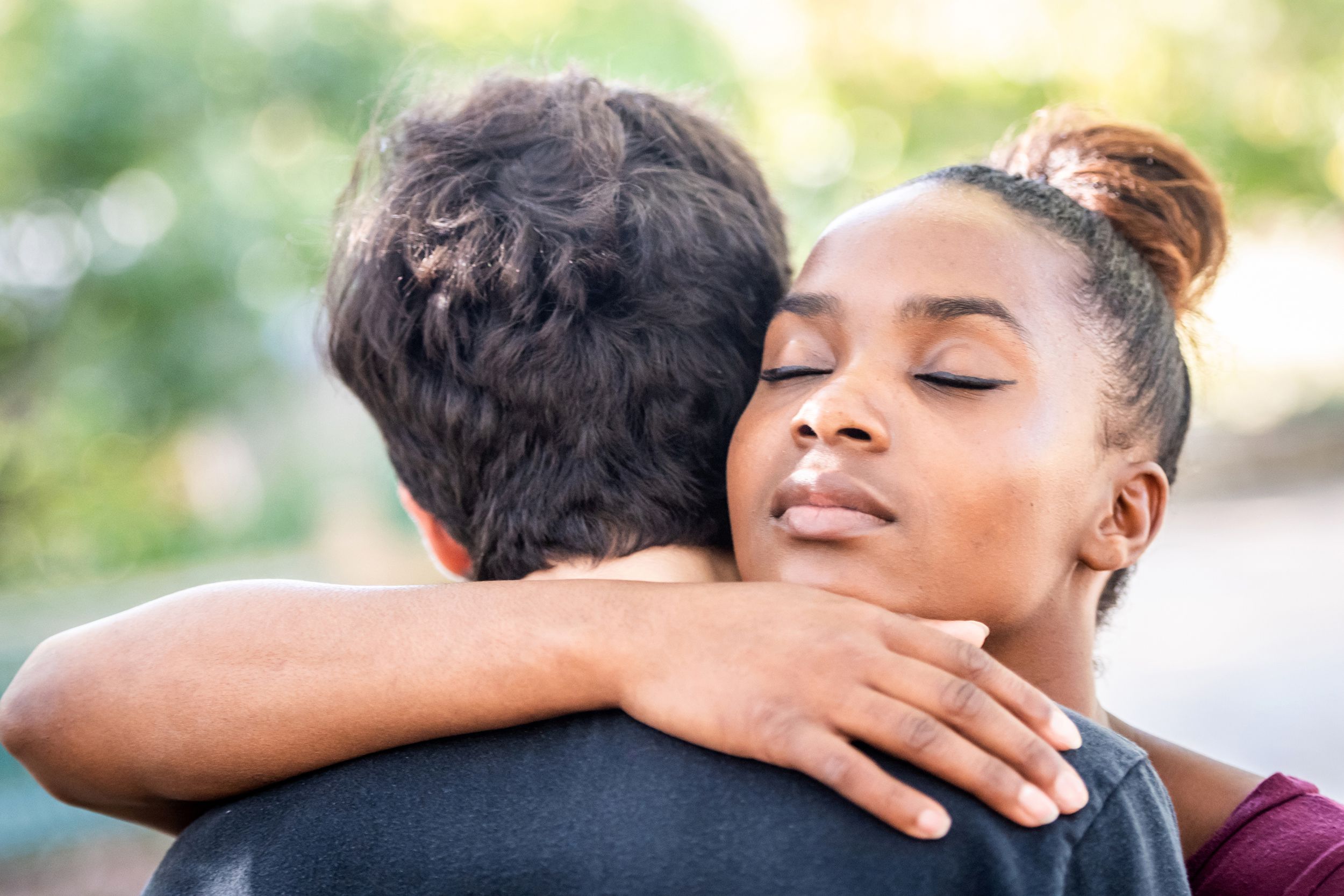 woman hugging a man outside