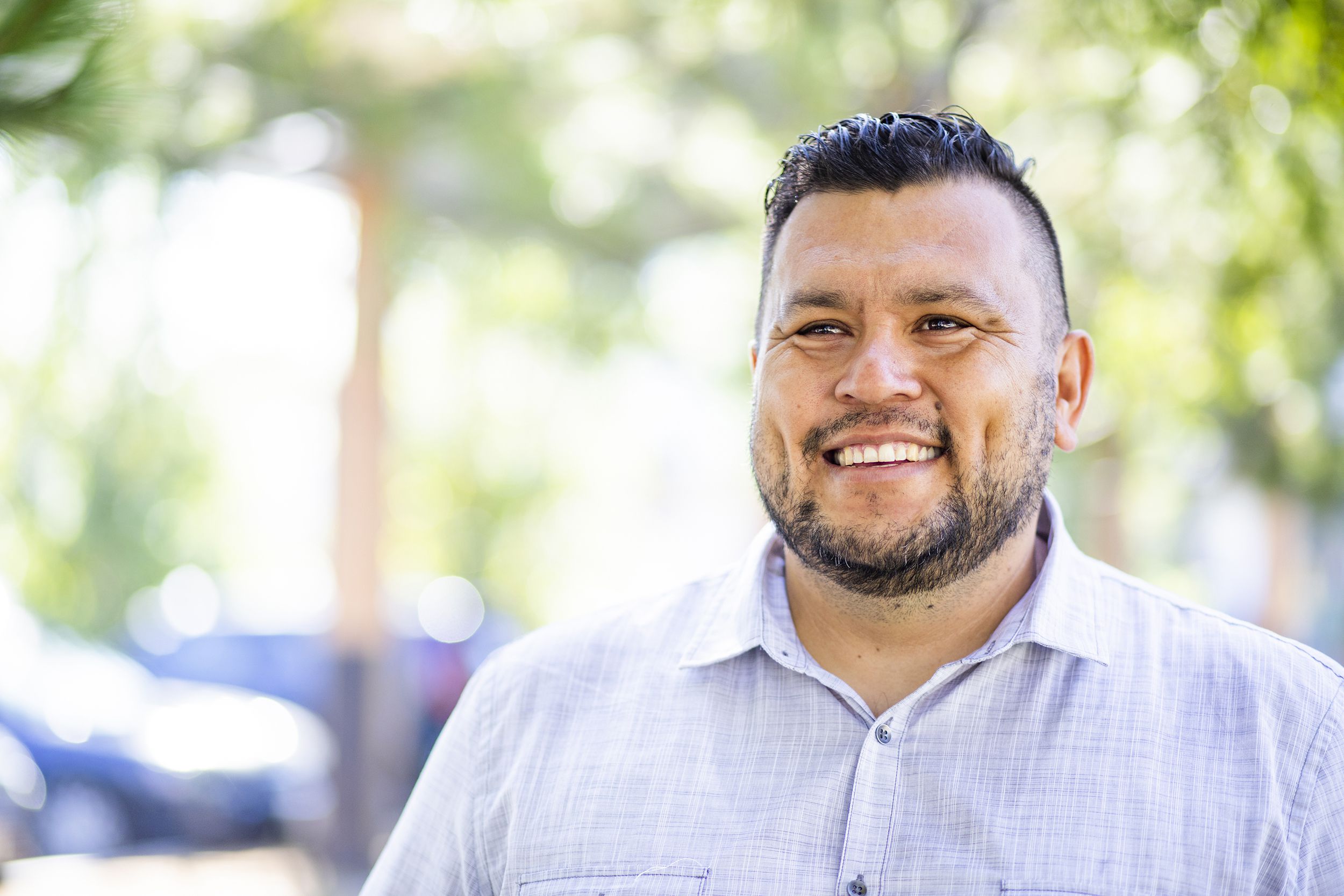 hispanic man smiling outside