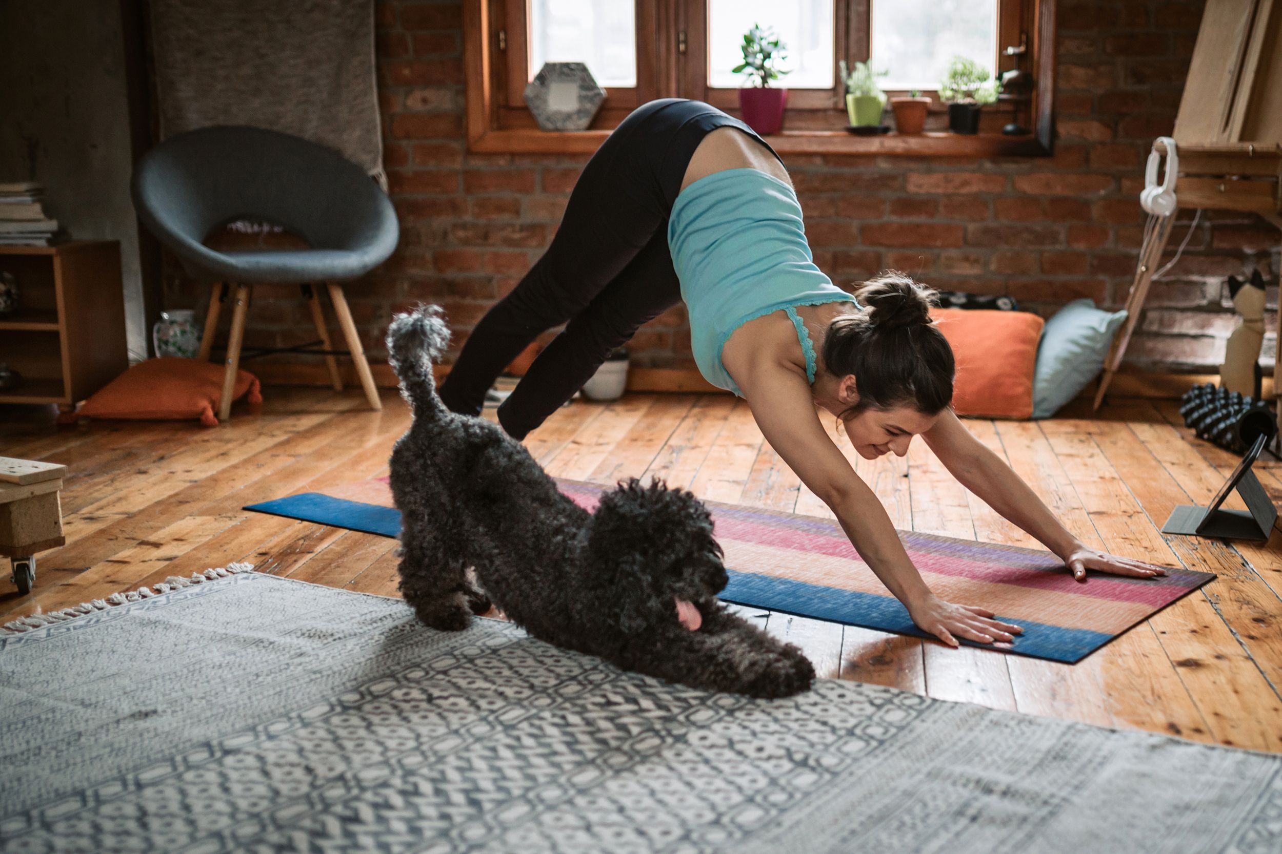 woman doing yoga at home with her