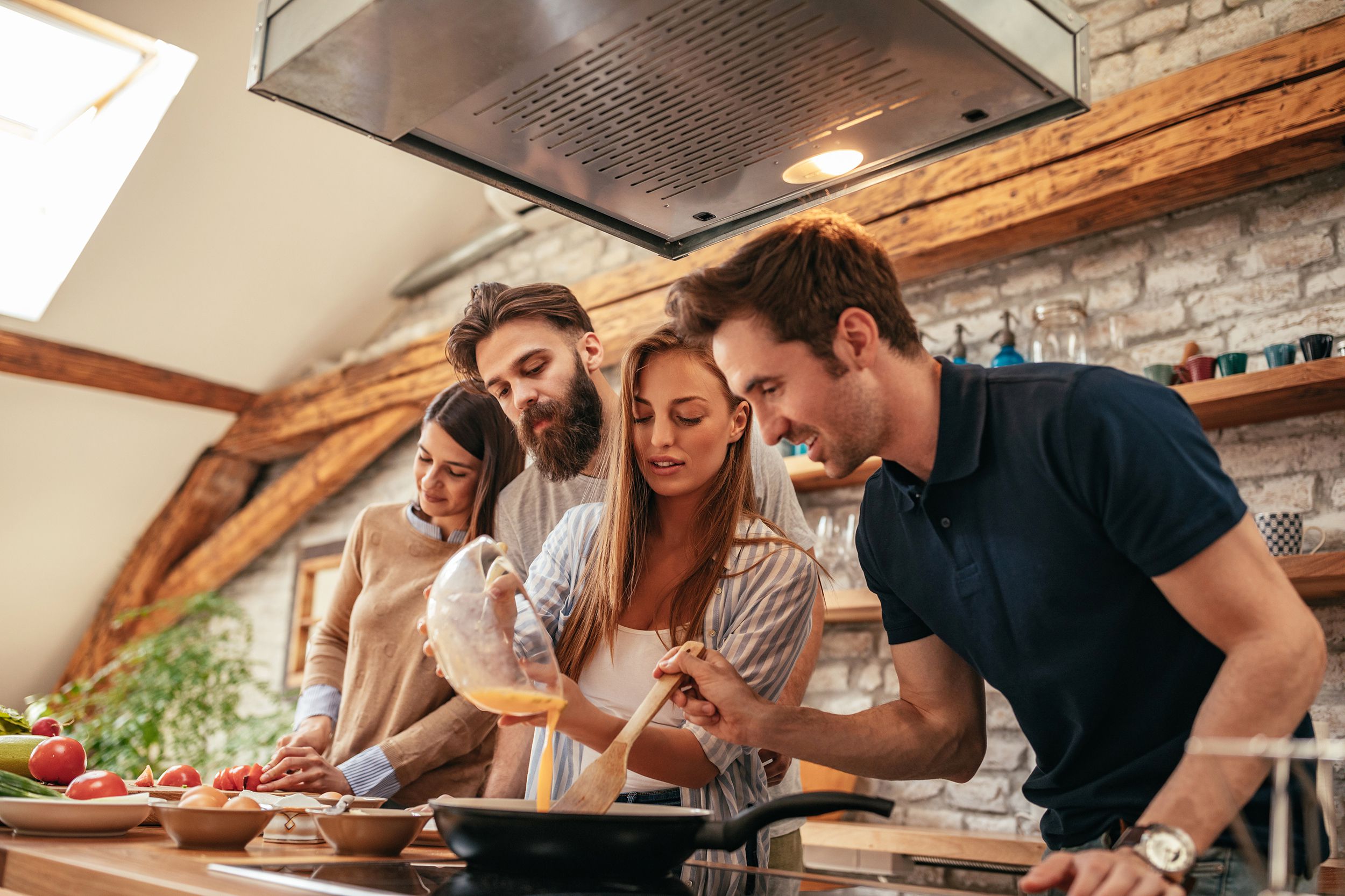 group of friends cooking at home