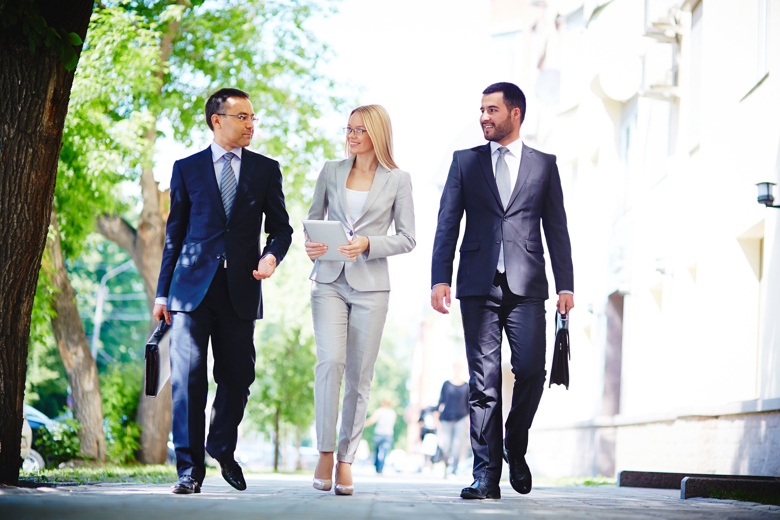 colleagues walking and discussing business matters on the move