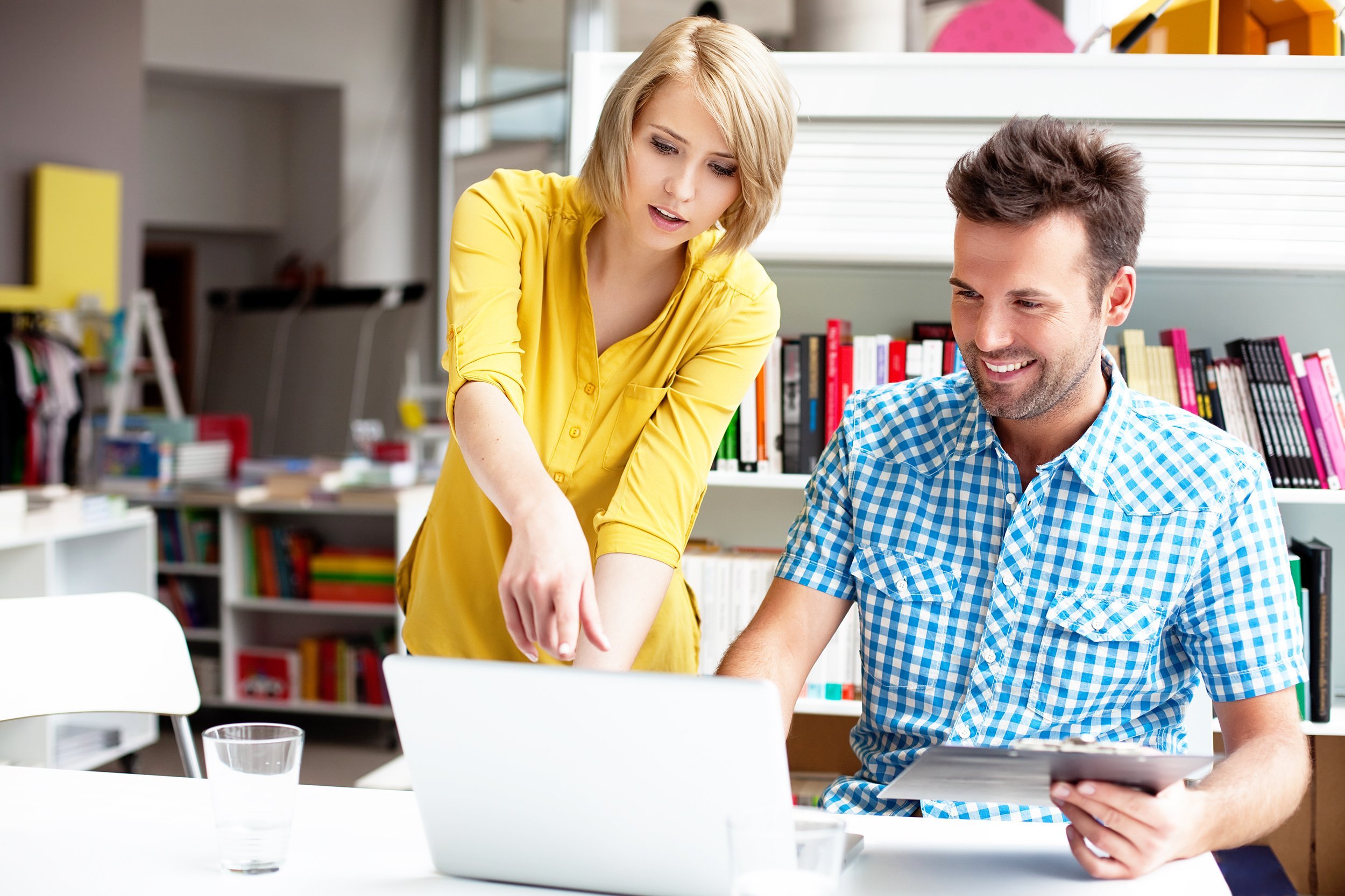 two bookshop managers working on laptop