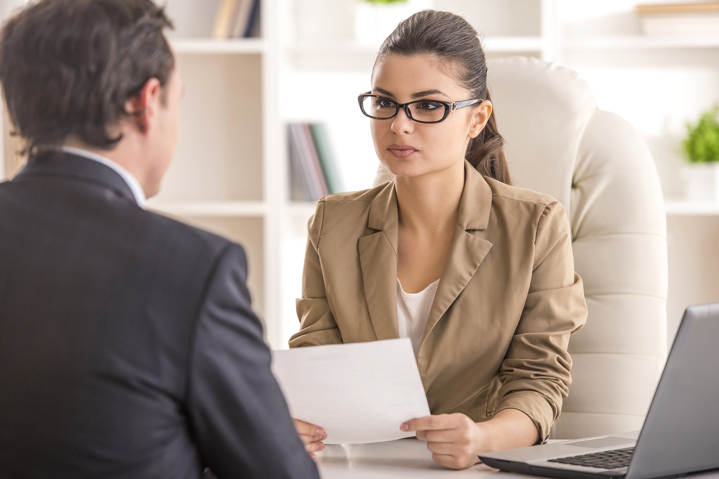 businesswoman interviewing male candidate for job in office