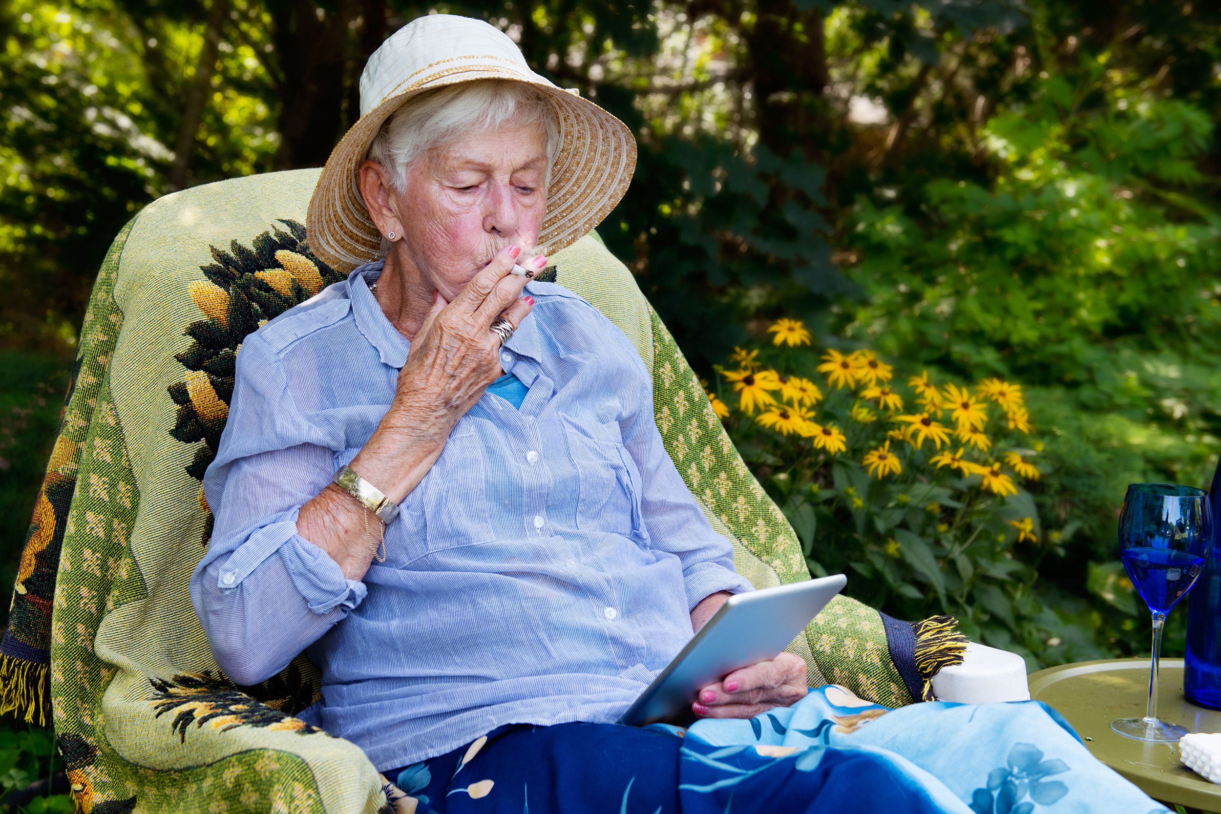 happy senior woman smoking marijuana joint