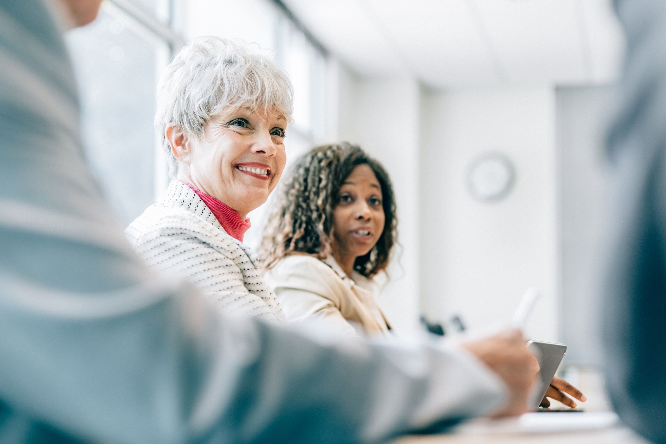 smiling senior woman in business meeting