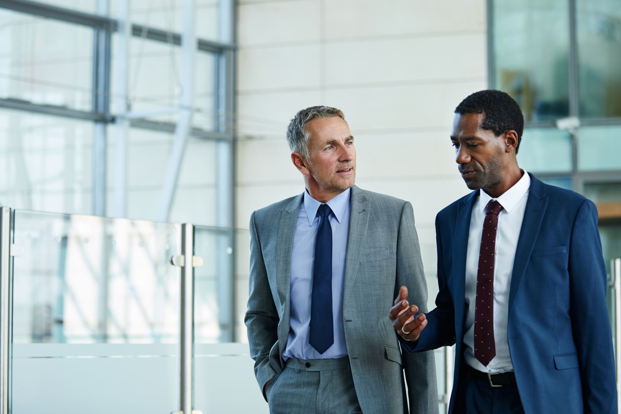 two businessmen talking outside office