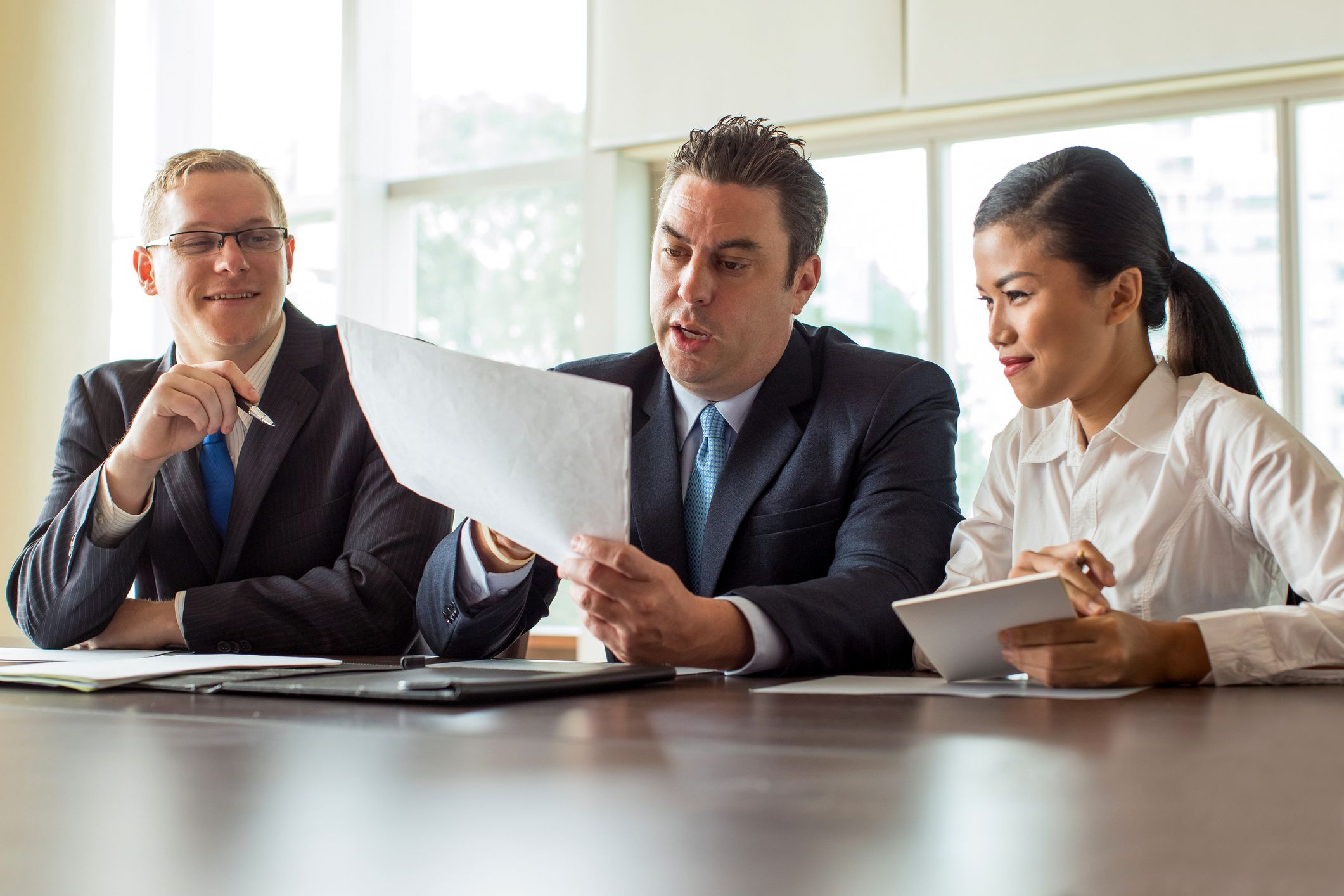 three colleagues meeting and reviewing portfolio
