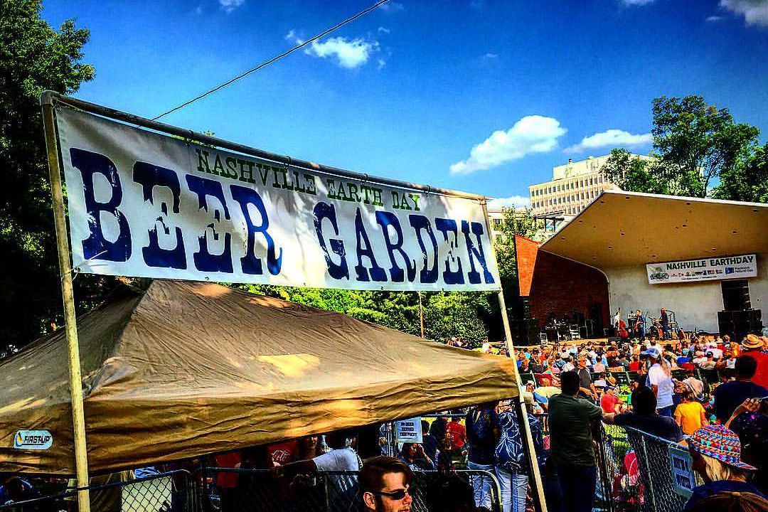 nashville earth day beer garden sign, stage in background