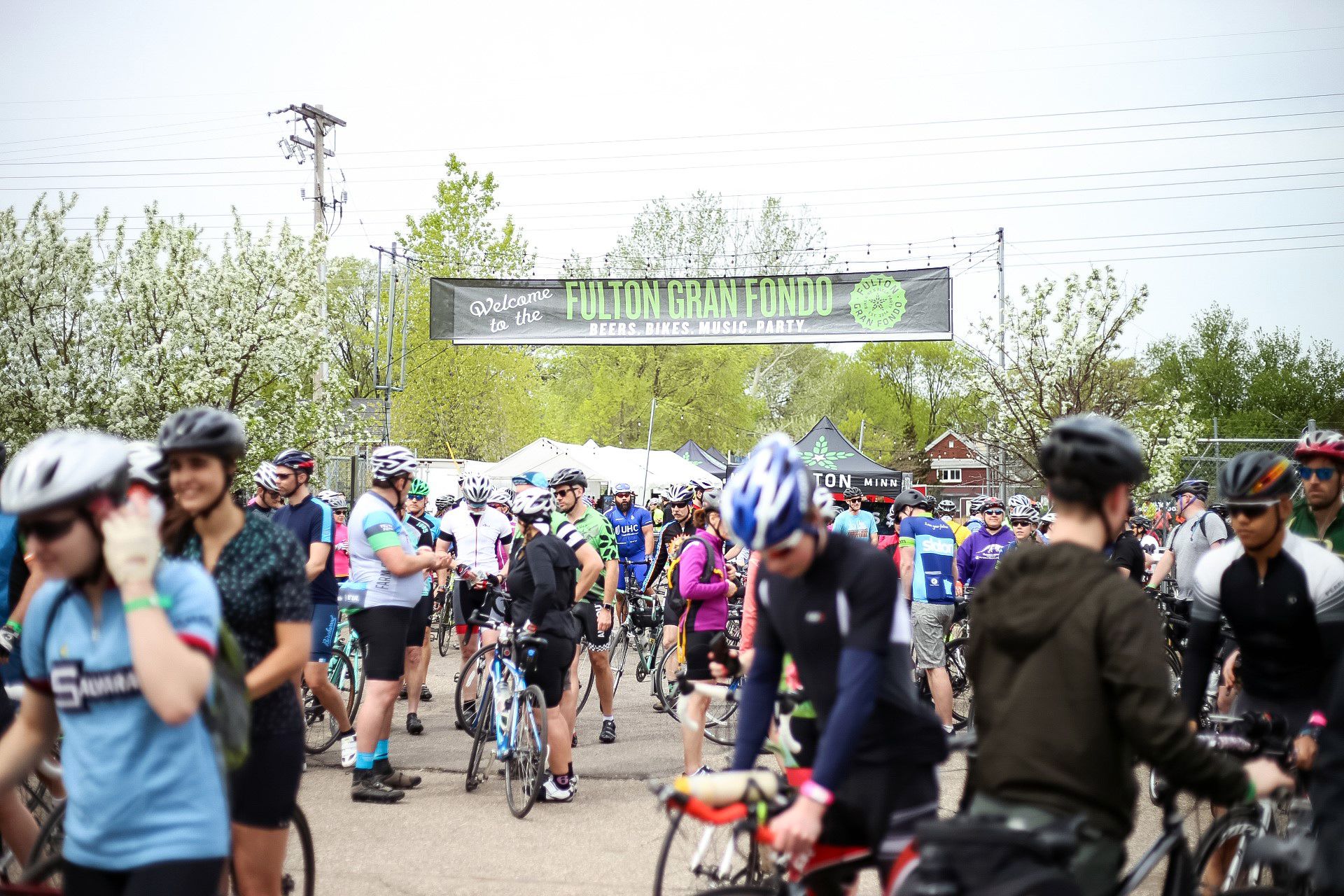 bikers at the fulton gran fondo, banner in background