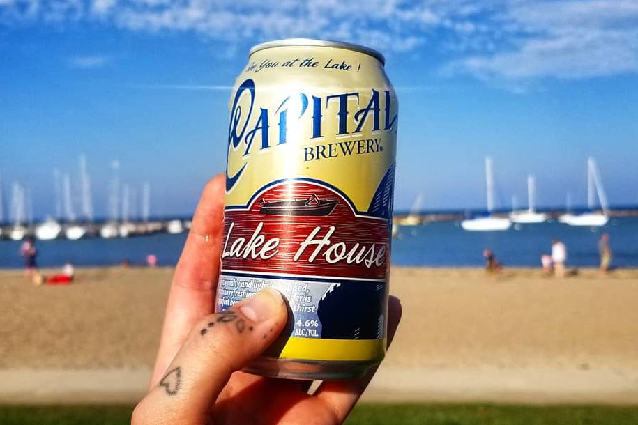 can of capital brewery lake house beer in front of lake