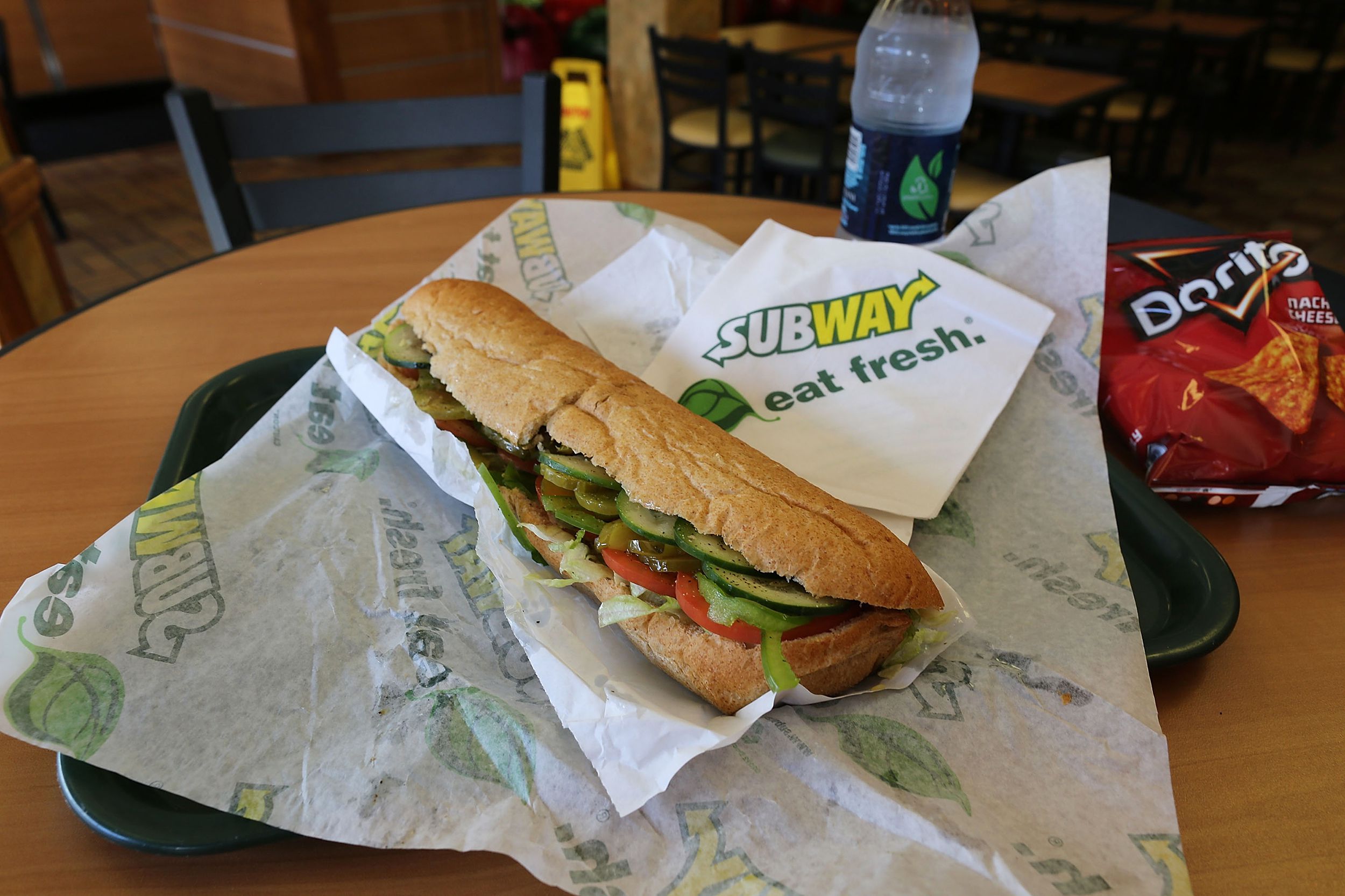 A Subway sandwich is seen in a restaurant.