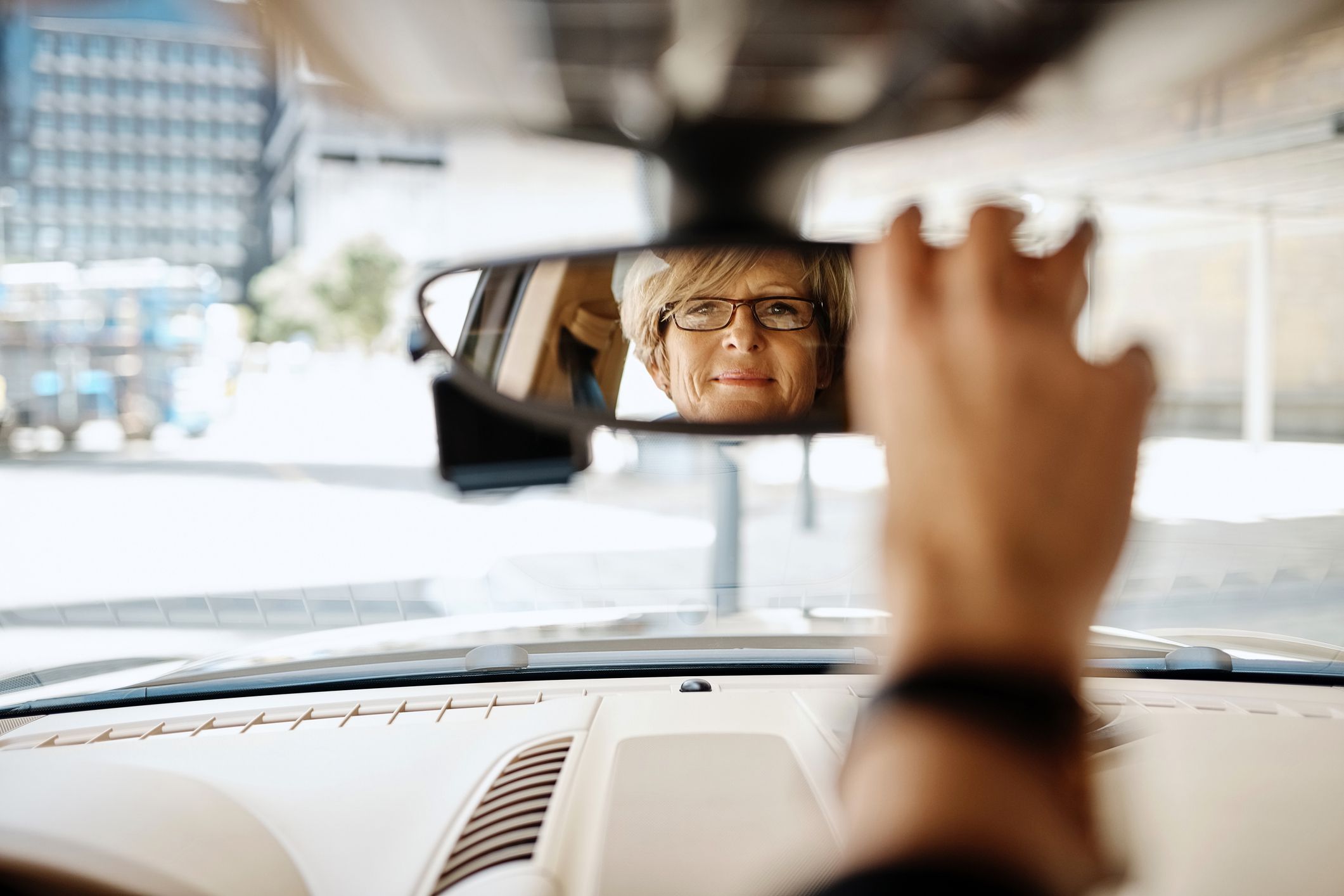 woman checking rearview mirror