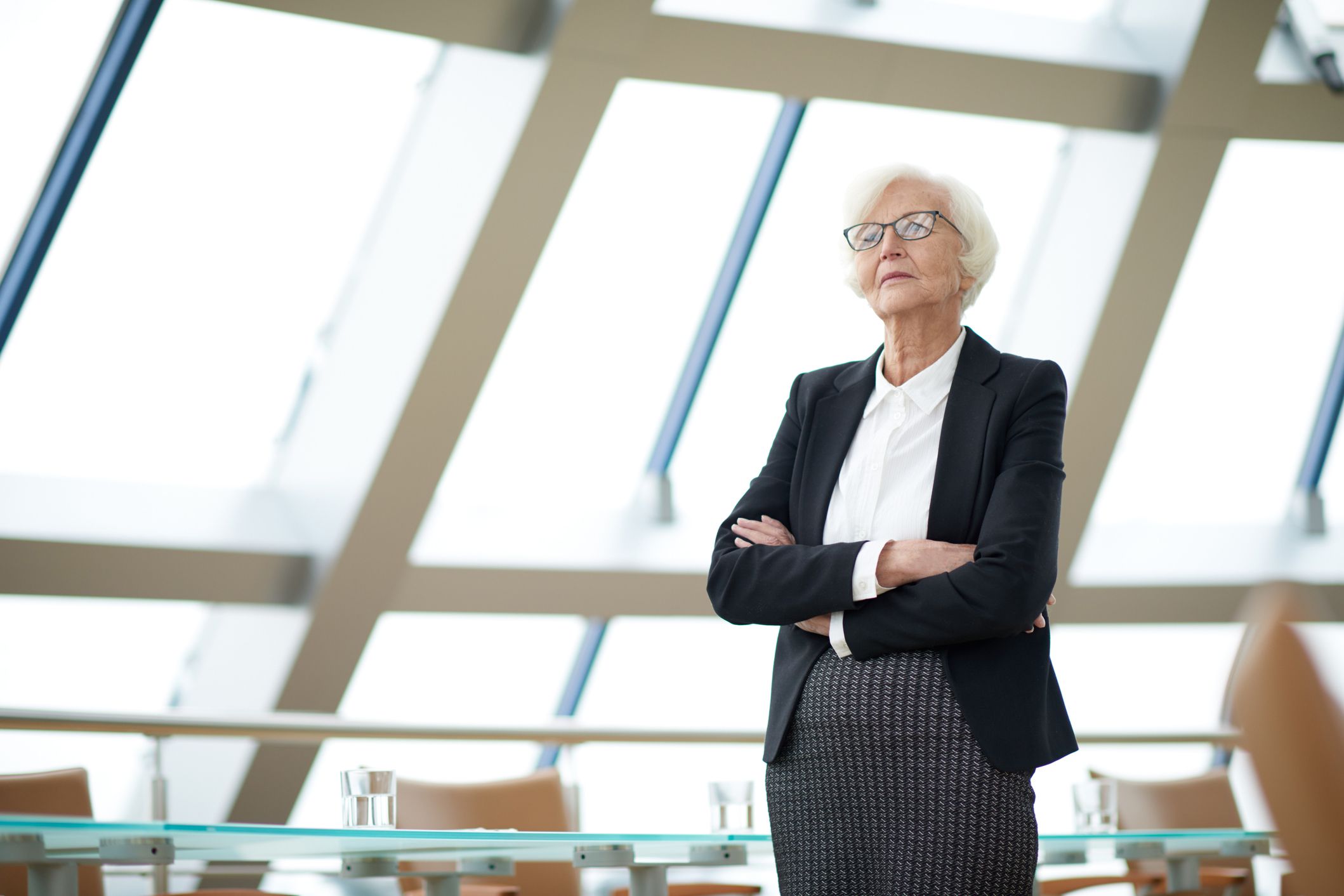 thoughtful businesswoman looking out window