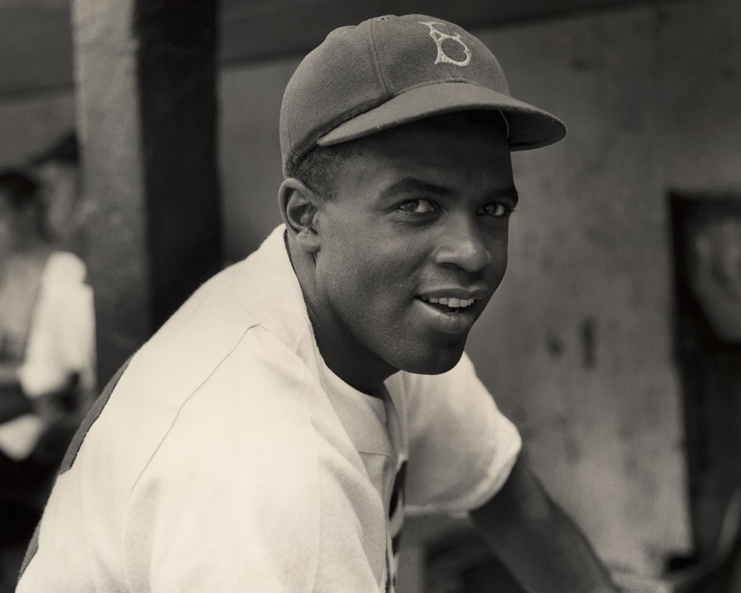 A portrait of the Brooklyn Dodgers' infielder Jackie Robinson in uniform.