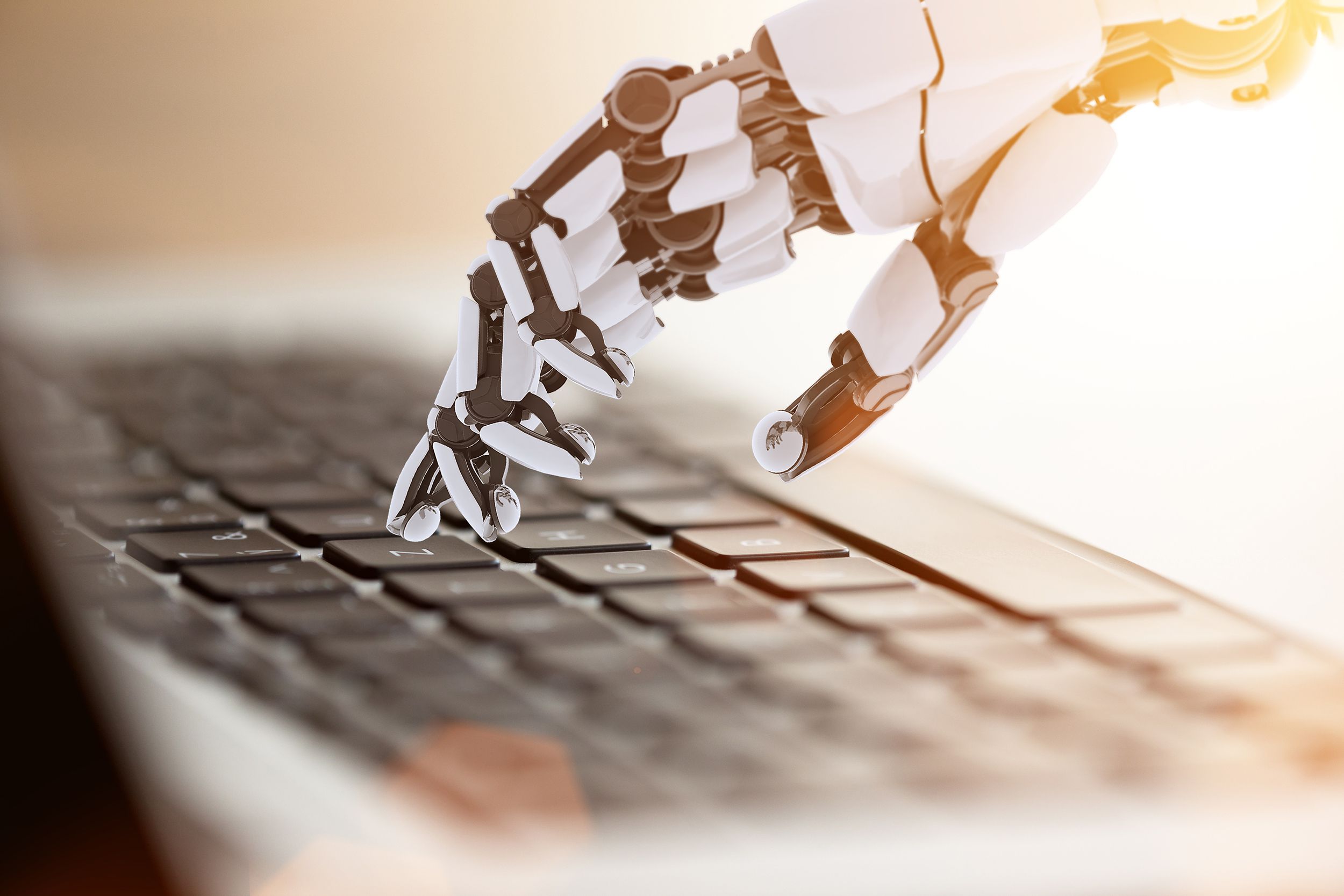 bot hand typing on laptop keyboard
