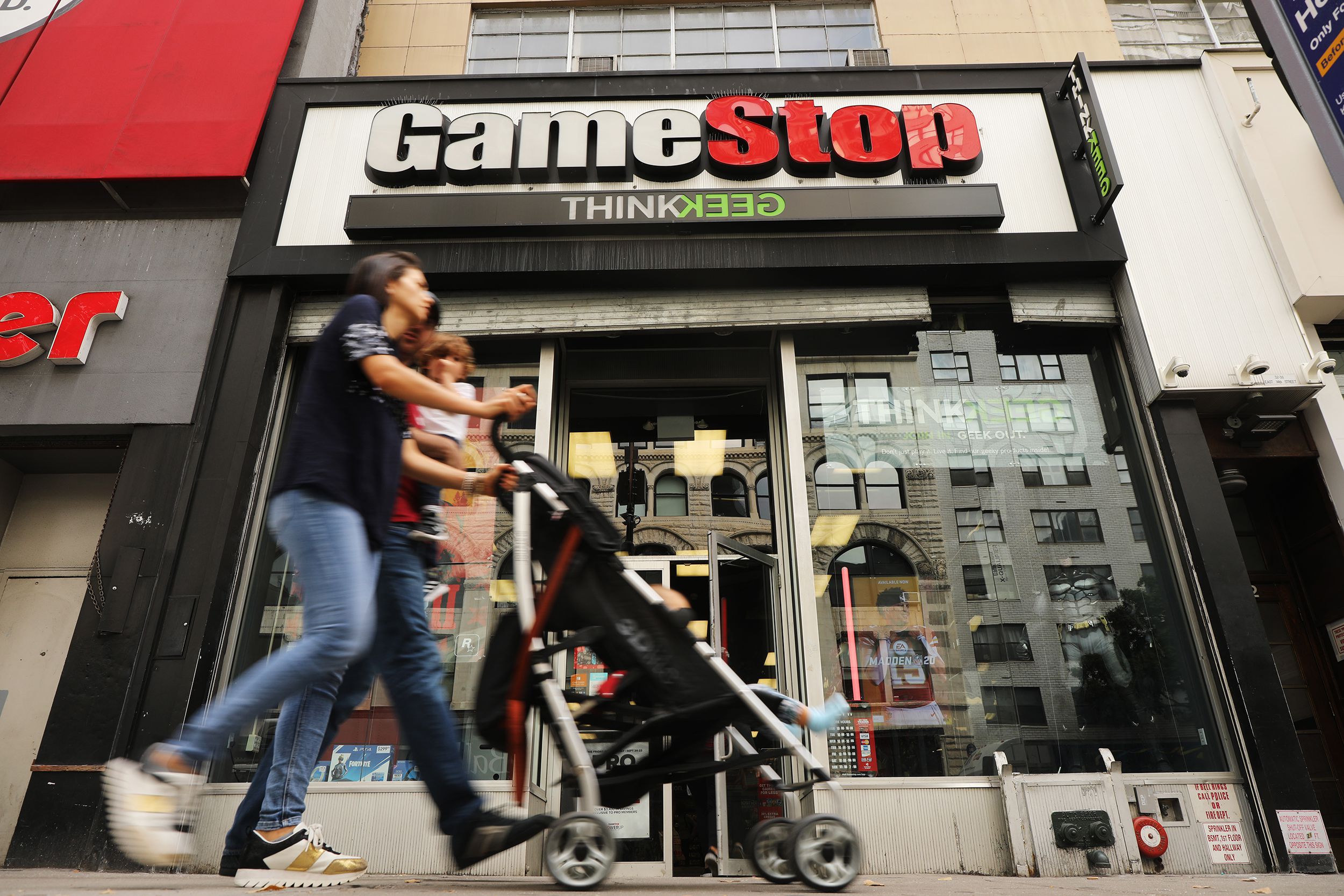 People pass a GameStop store in lower Manhattan on September 16, 2019 in New York City.