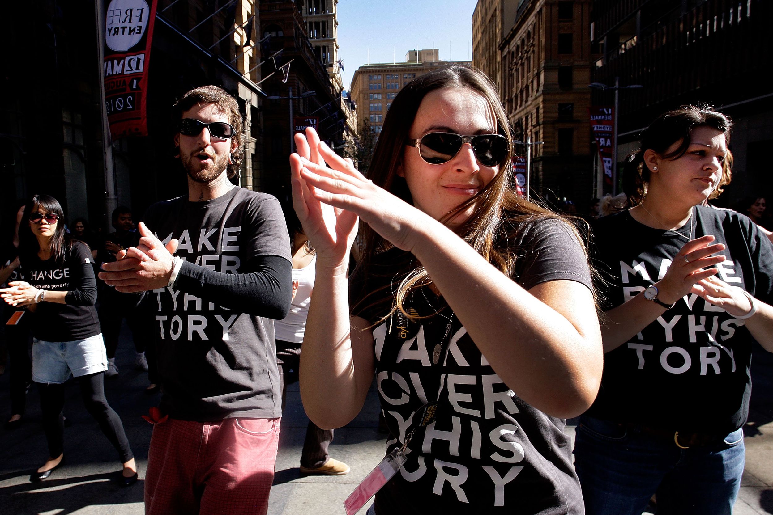 Members of the Make Poverty History campaign dance during a musical flash mob performance at Martin Place on May 11, 2010 in Sydney, Australia.