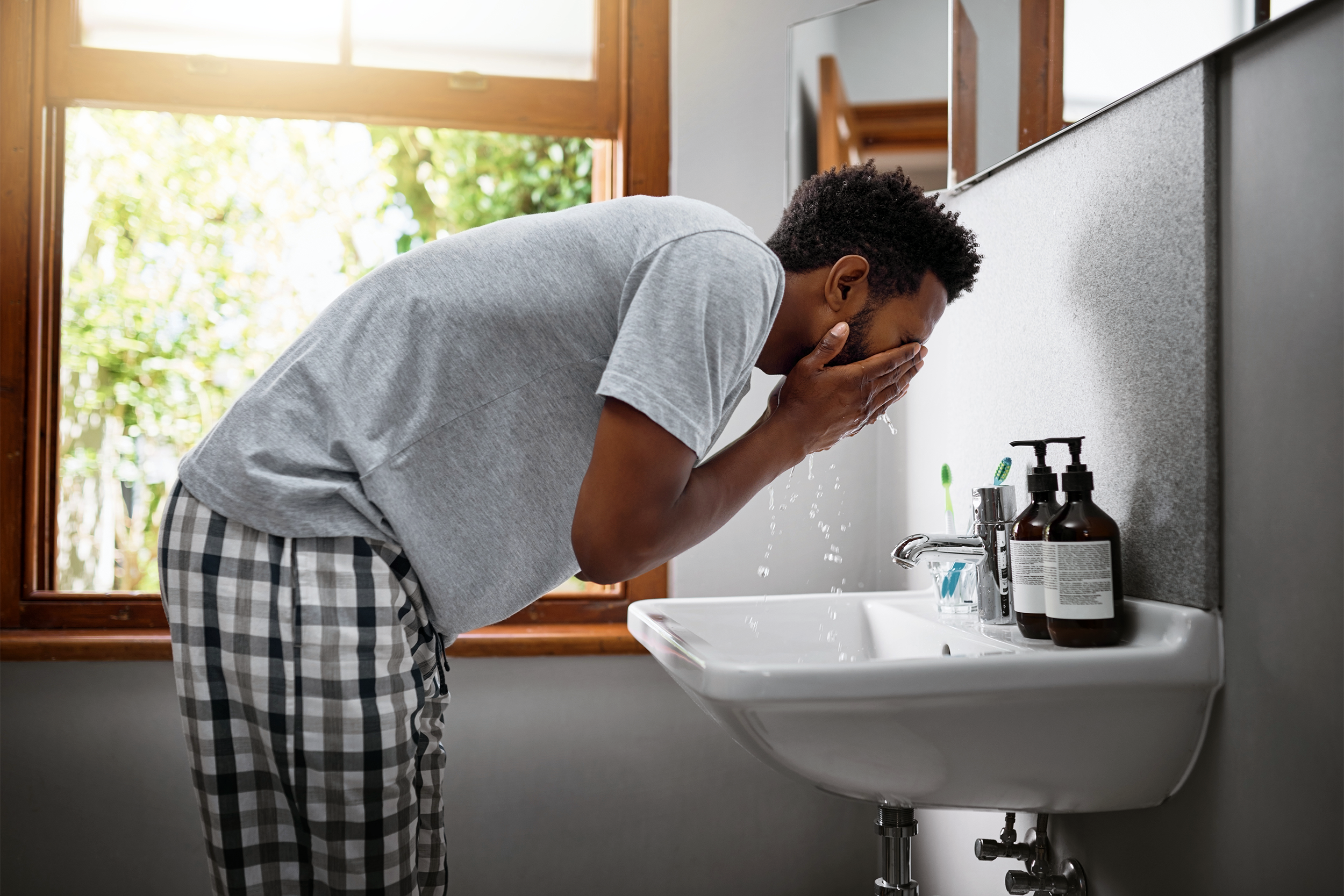 Man washing his face