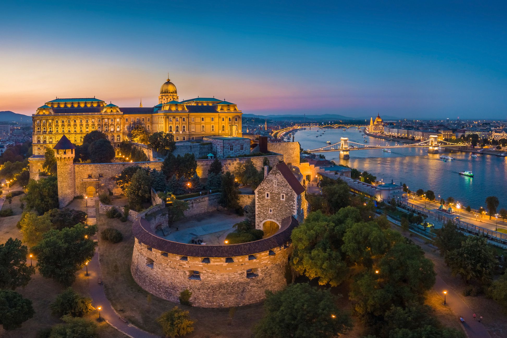 budapest, hungary - aerial panoramic skyline view of budapest with szechenyi chain bridge and buda district at blue hour