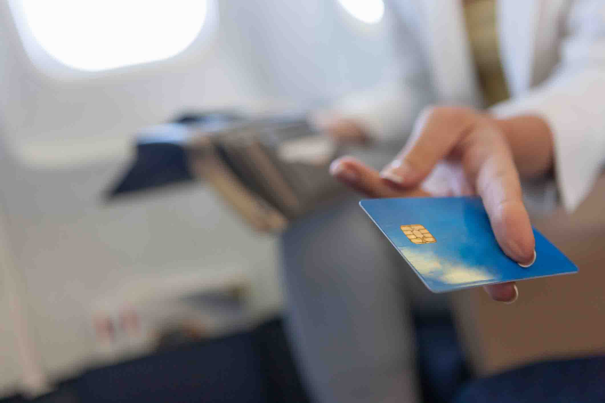 plane passenger holding out credit card