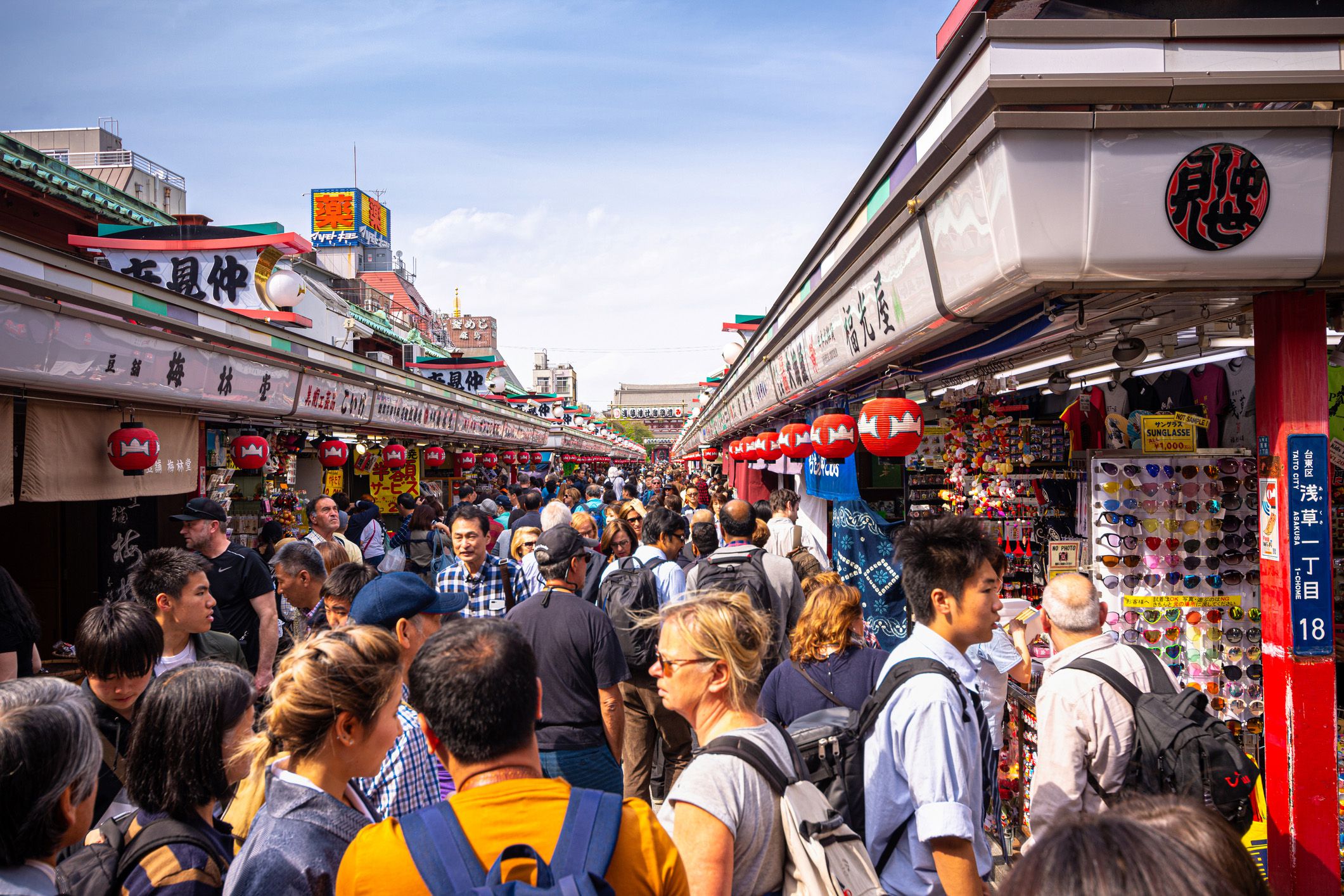 tourists visit nakamise shopping street leading up to sensoji temple in asakusa, tokyo, japan