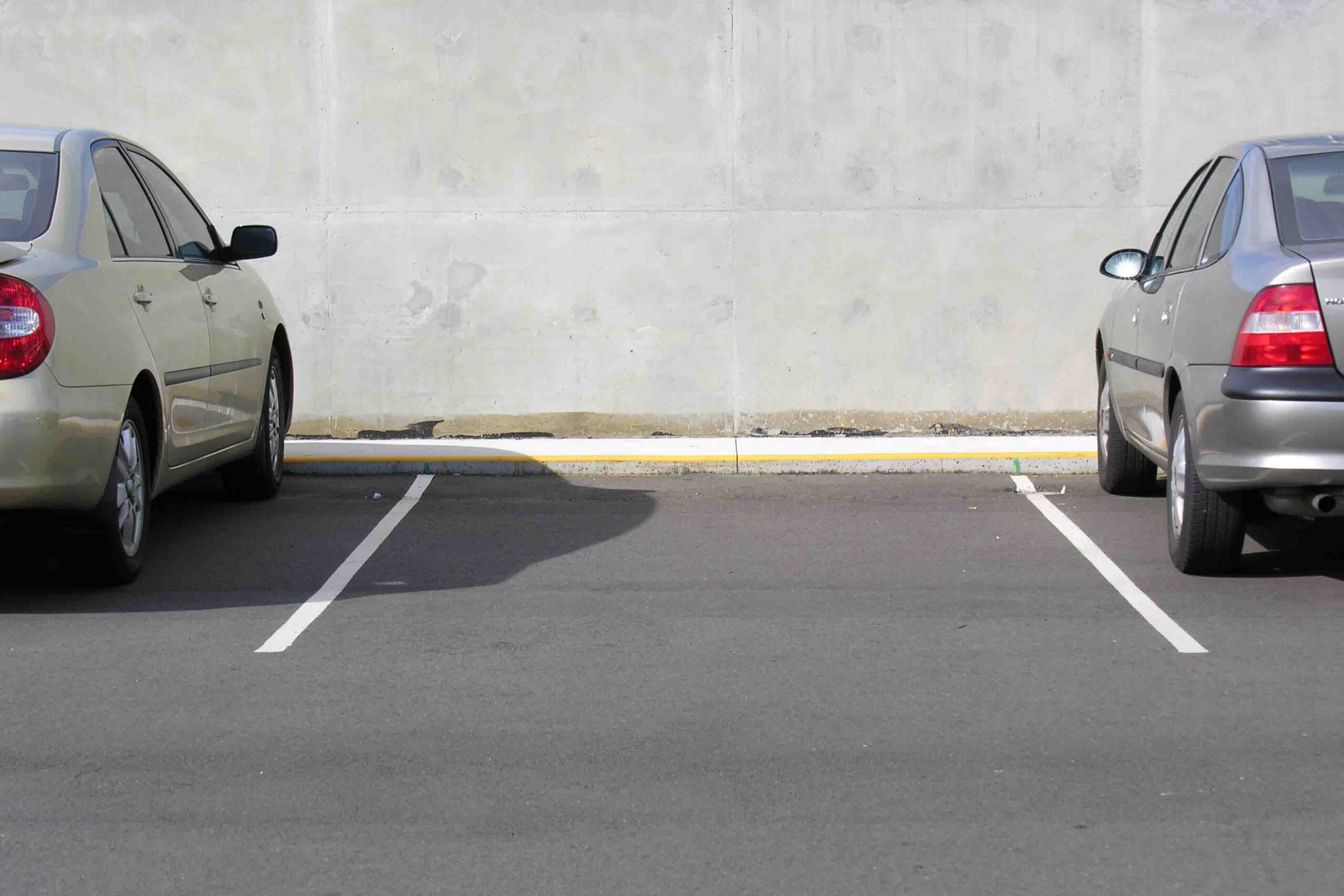 empty parking space between two cars in lot