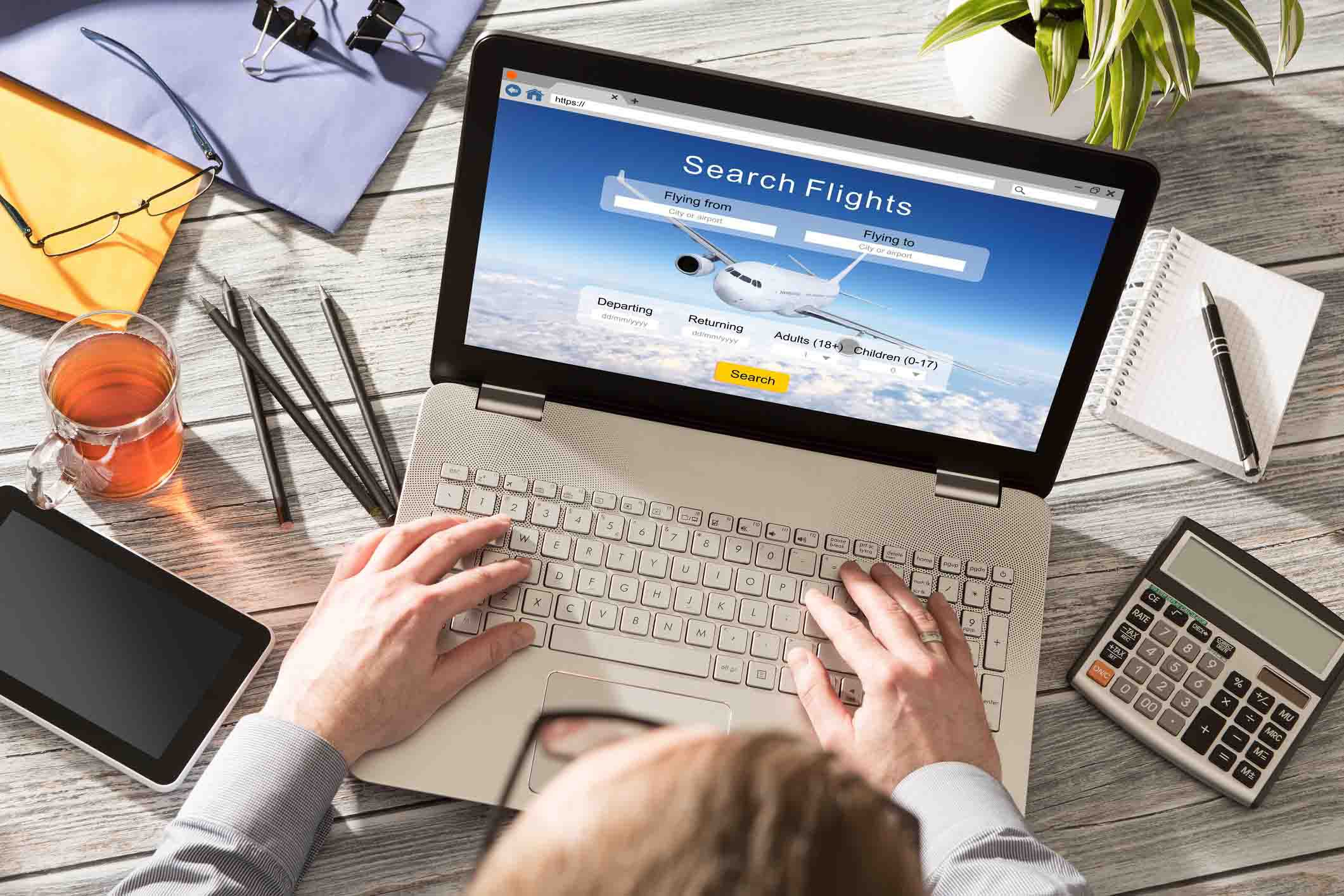 man on airfare website booking flight online