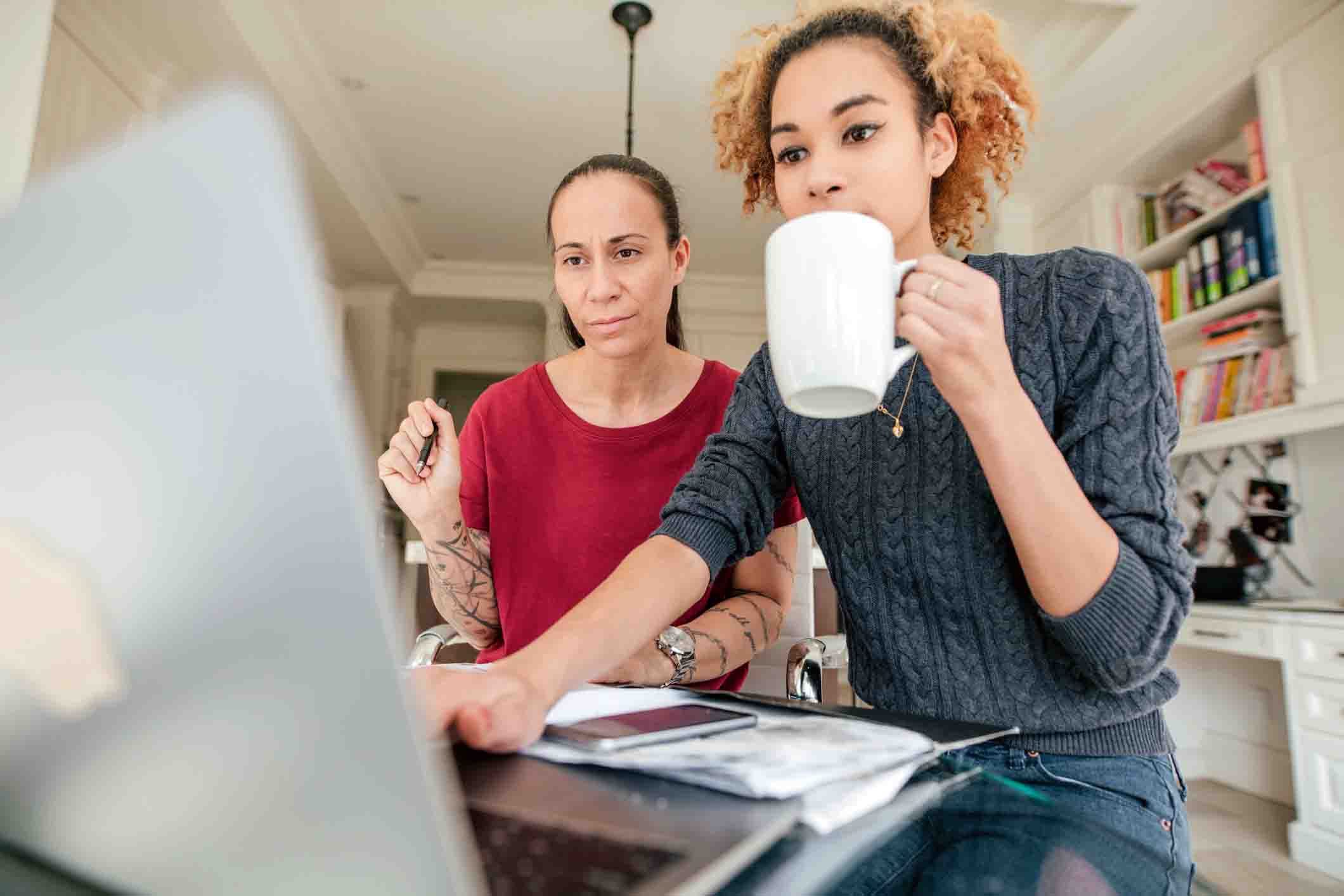 couple looking at laptop, organizing travel plan