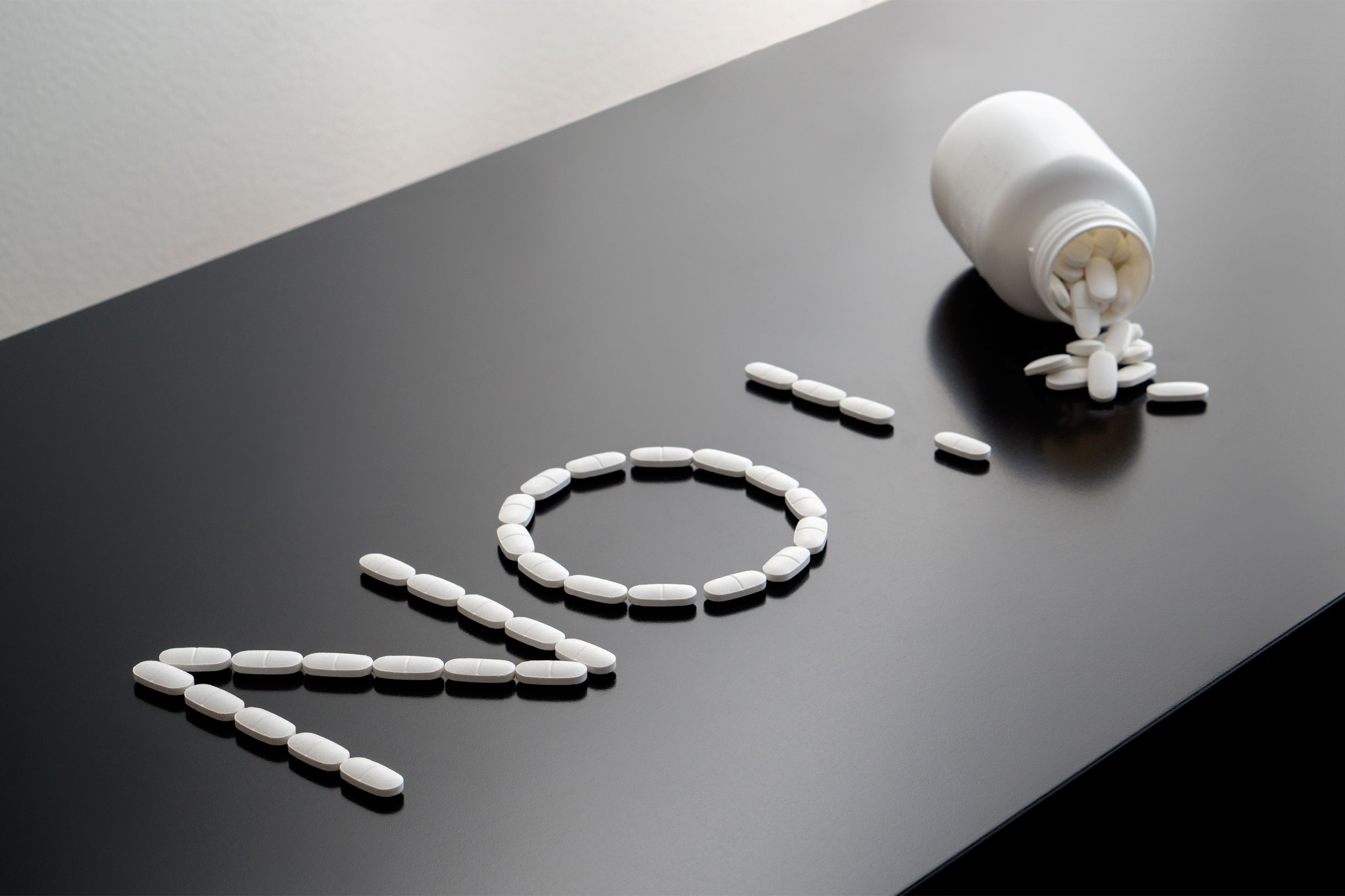 'No!' written in vitamins with container