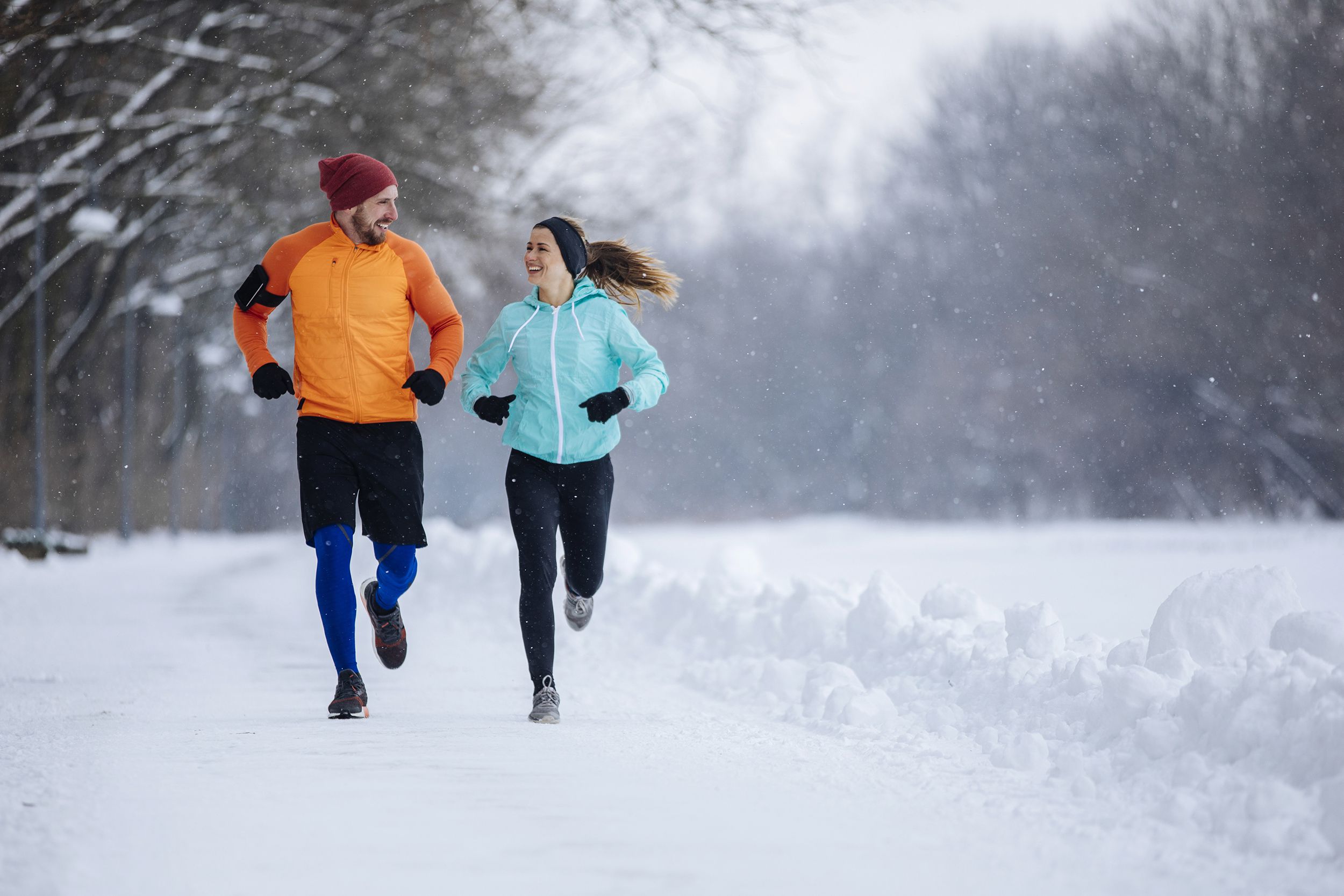 couple jogging on a snowy road