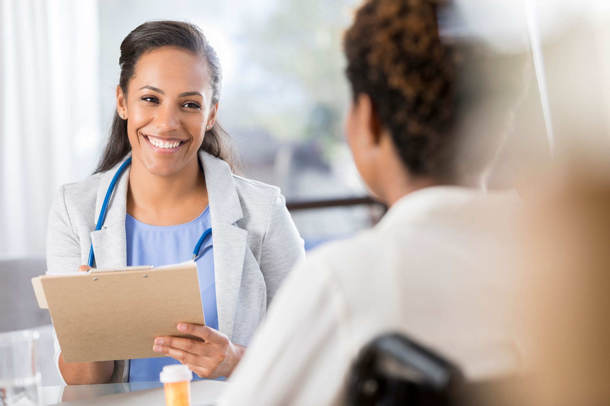 female doctor prescribes medication to a patient