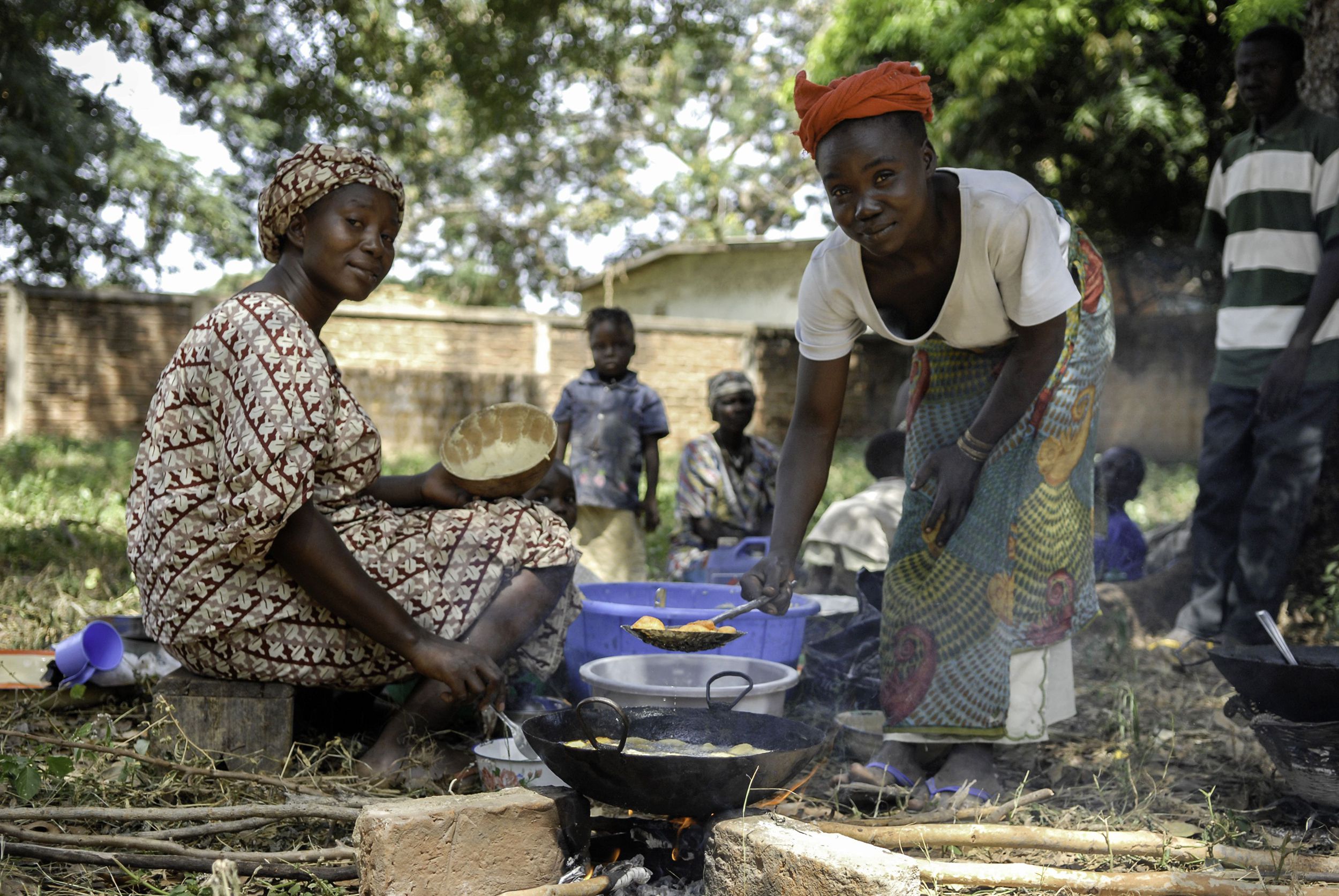 two women cooking food for family in Mondou, Chad