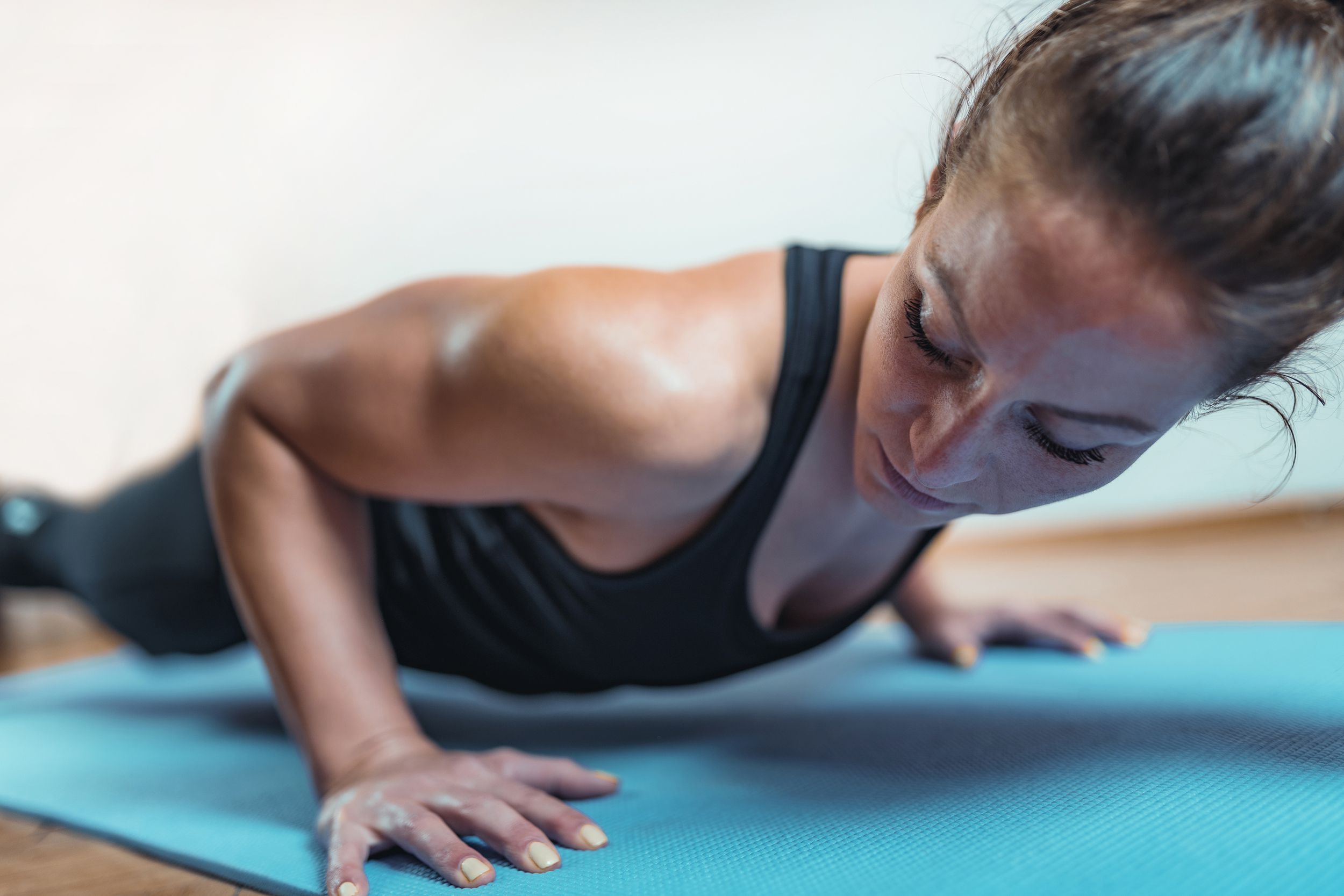 woman doing Micro-HIIT at home on yoga mat