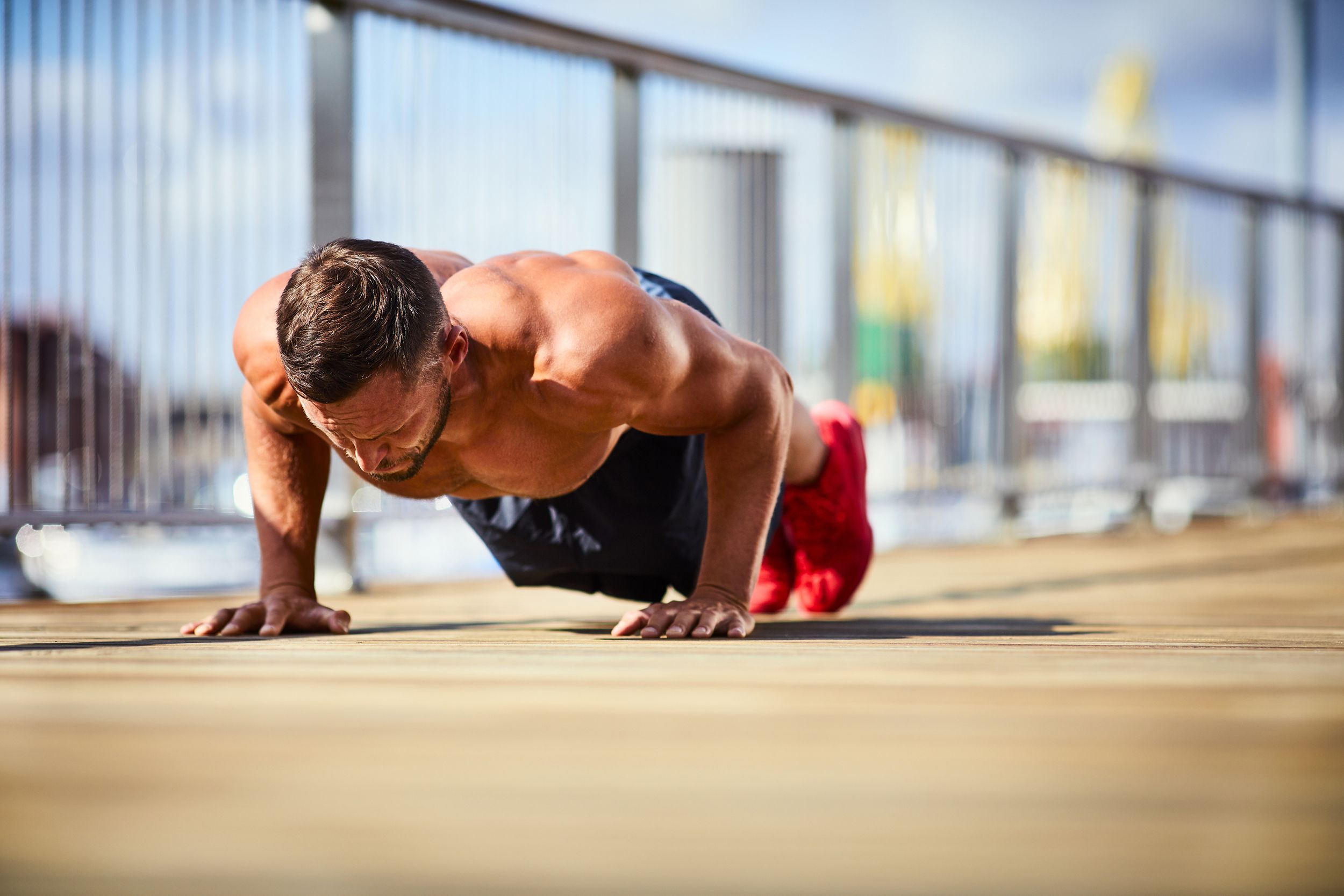 athletic man doing push-ups outside
