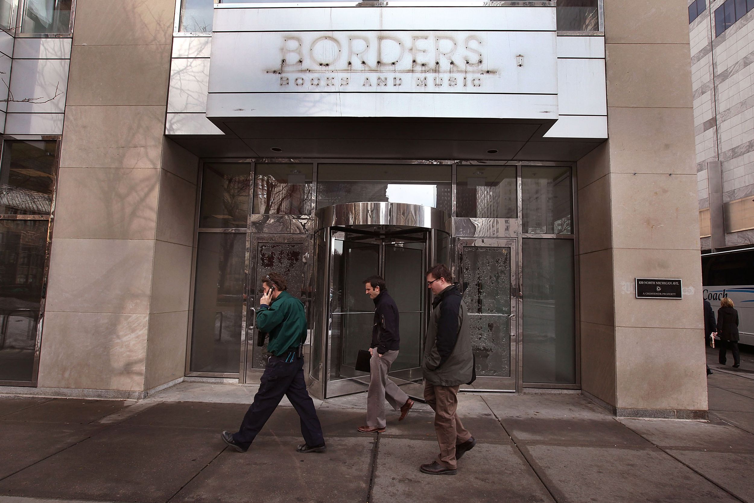 Pedestrians walk past a shuttered Borders bookstore along the Michigan Avenue shopping district on February 16, 2011 in Chicago, Illinois.