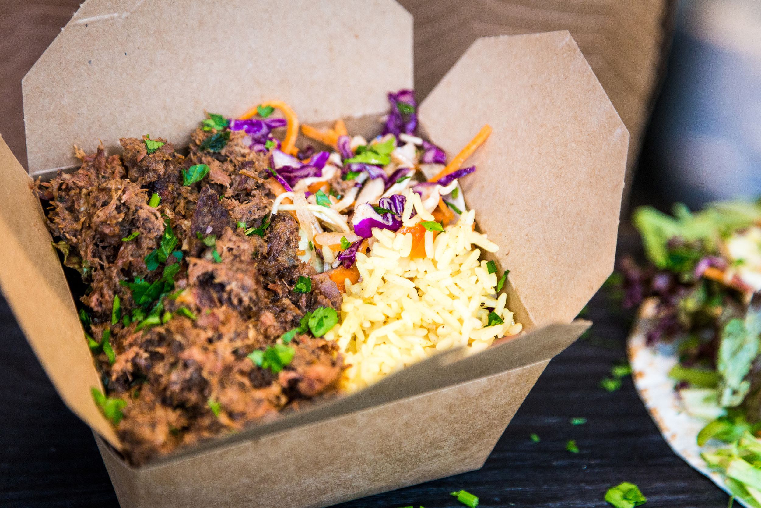 pulled pork, rice and salad in take out food at street food market