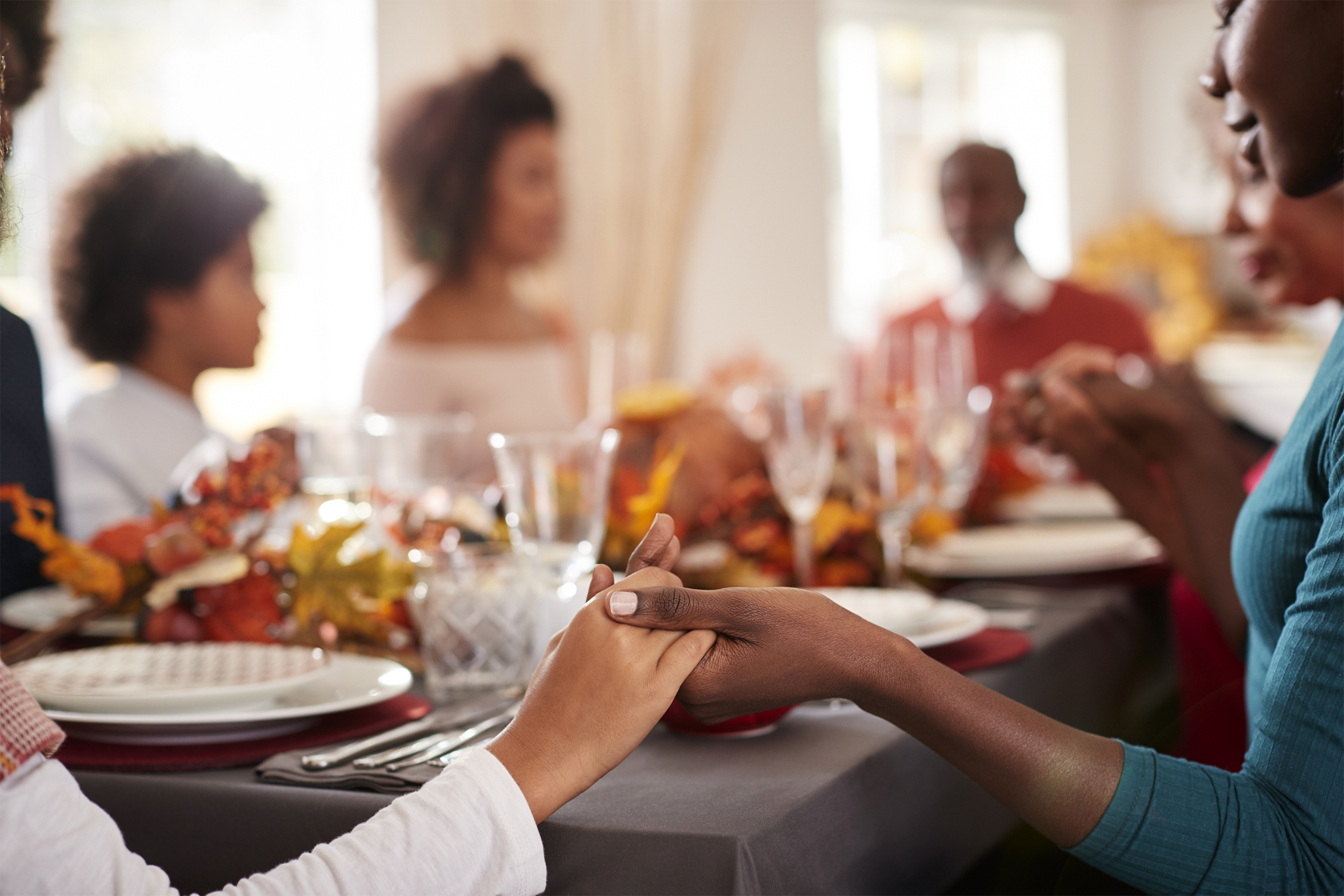 Holding hands at Thanksgiving table