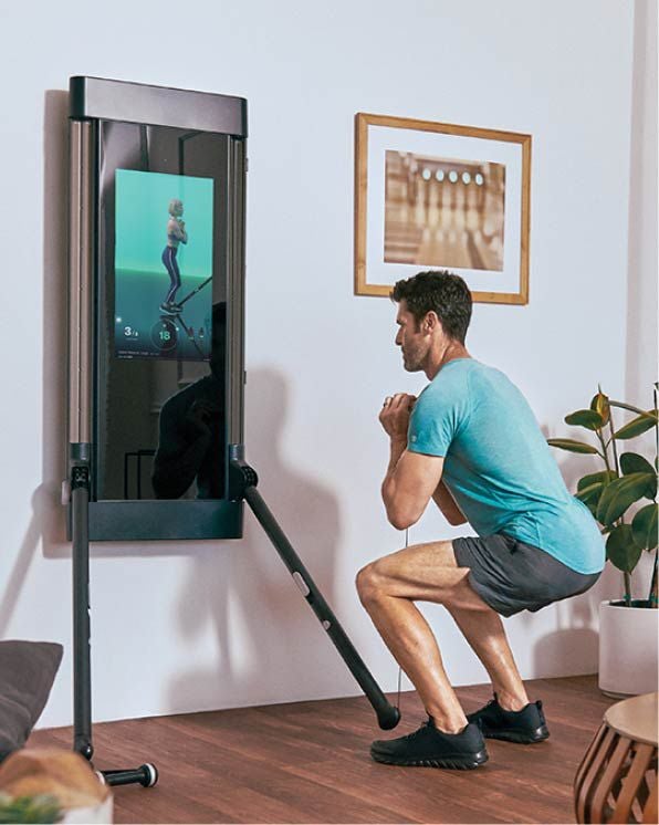man doing in-home workout with Tonal