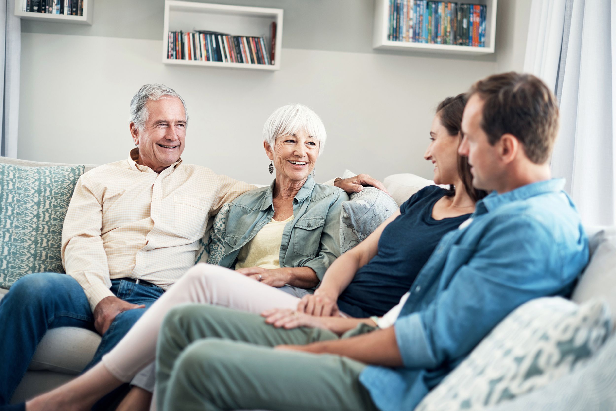 shot of a young couple and their elderly parent spending some time together at home