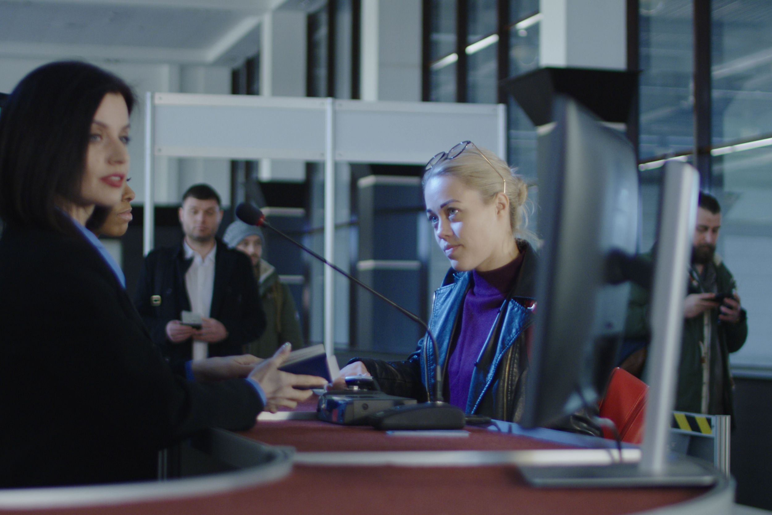airport security personnel processing passengers