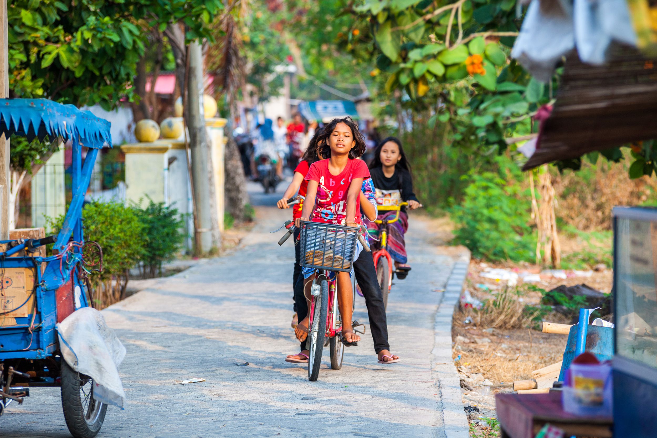 young girls going around the island with their bicycles in Thousand Islands in Jakarta, Indonesia
