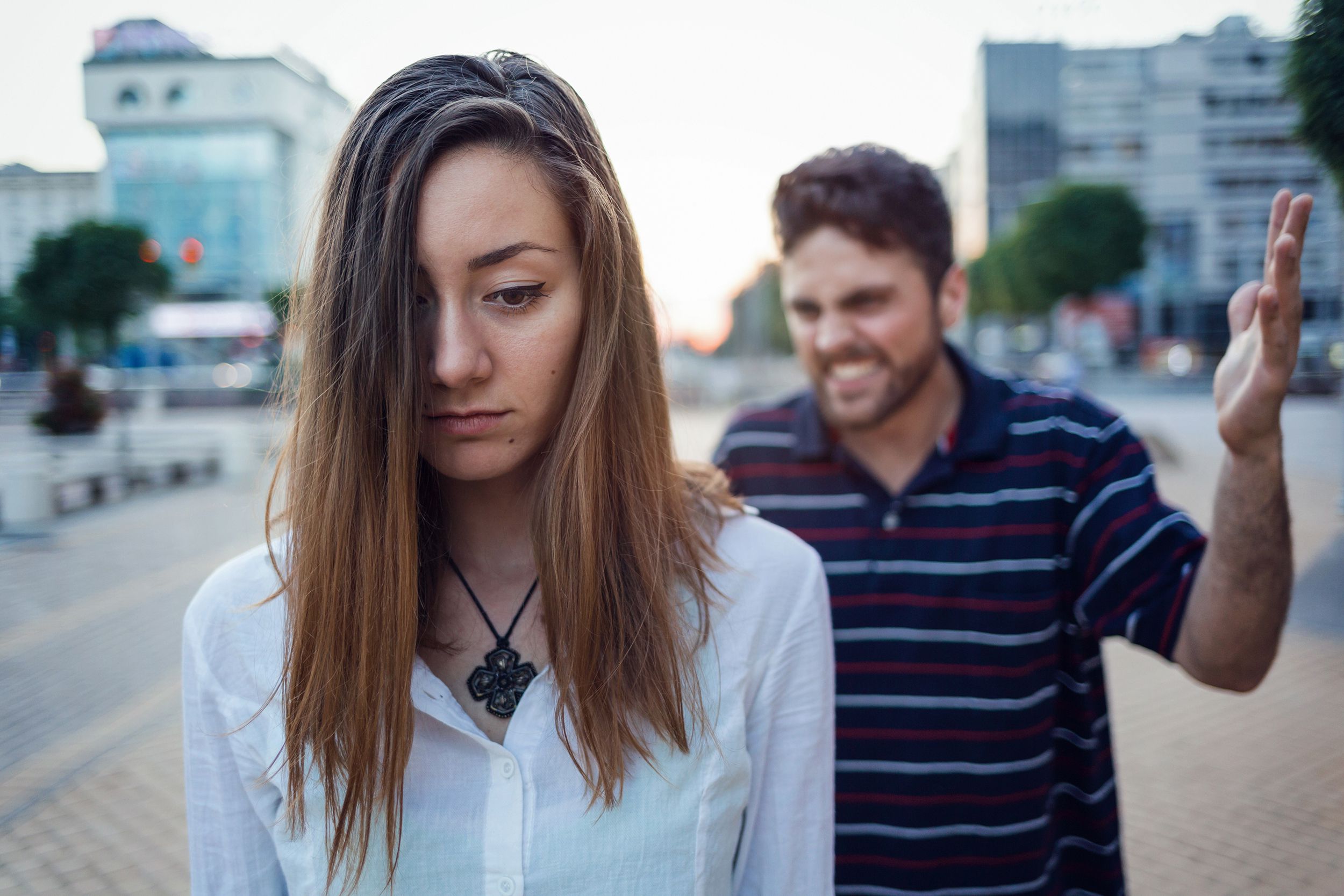 guy following woman in couple outside