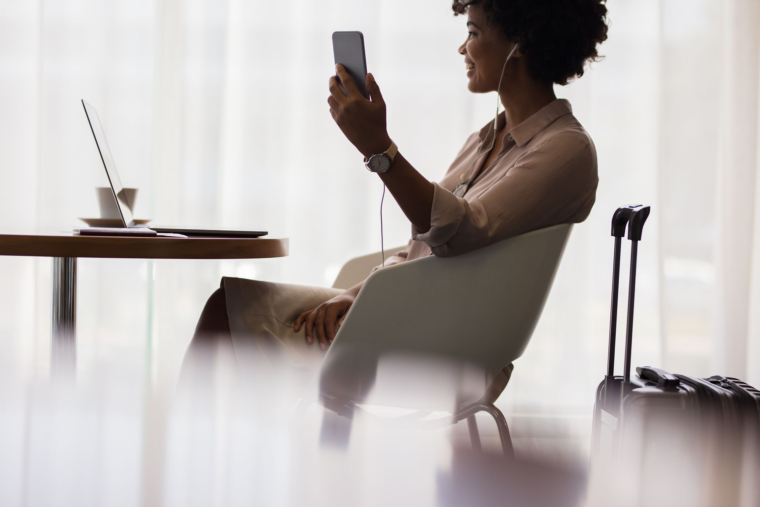 woman at airport lounge making video call