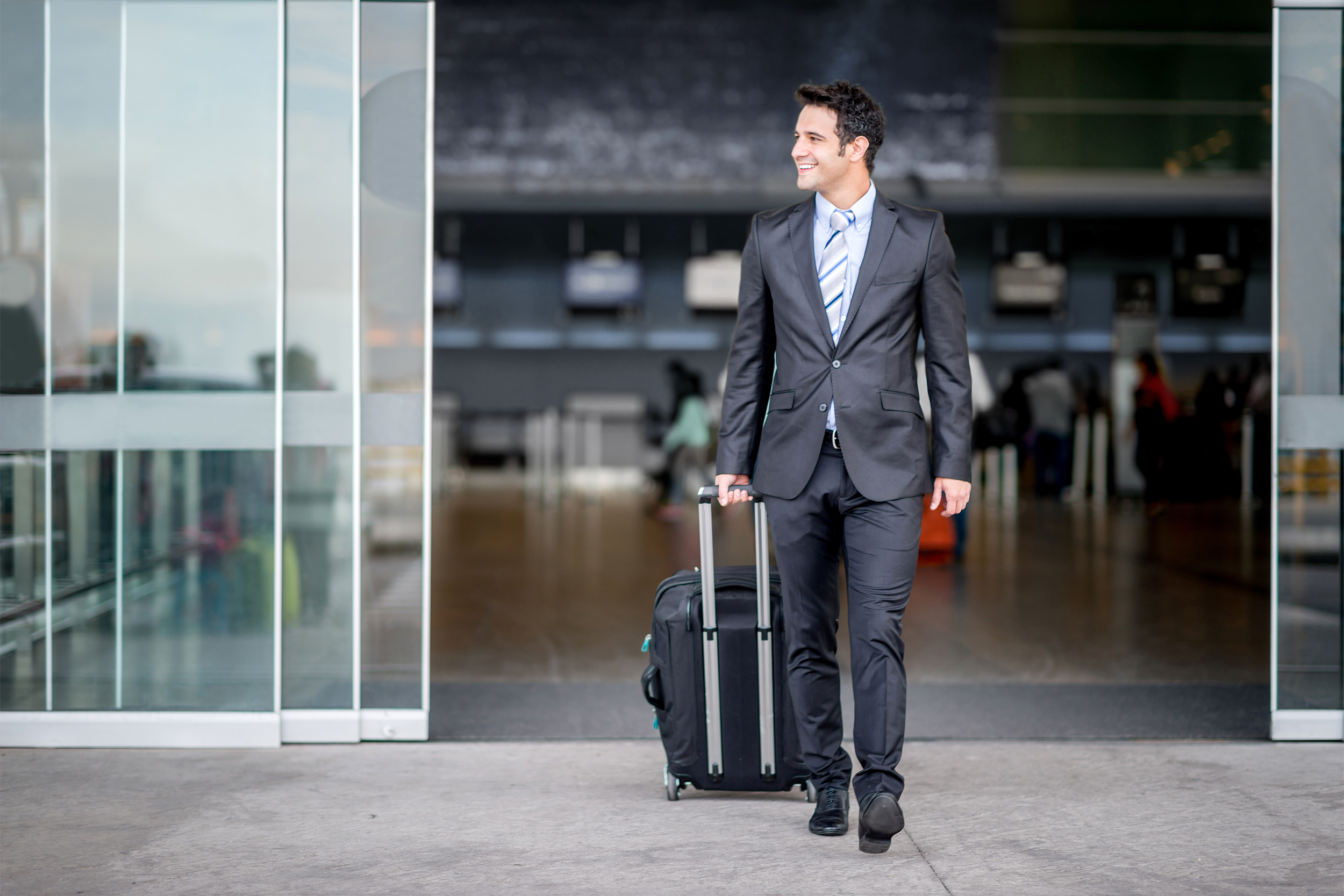 business man walking out of an airport