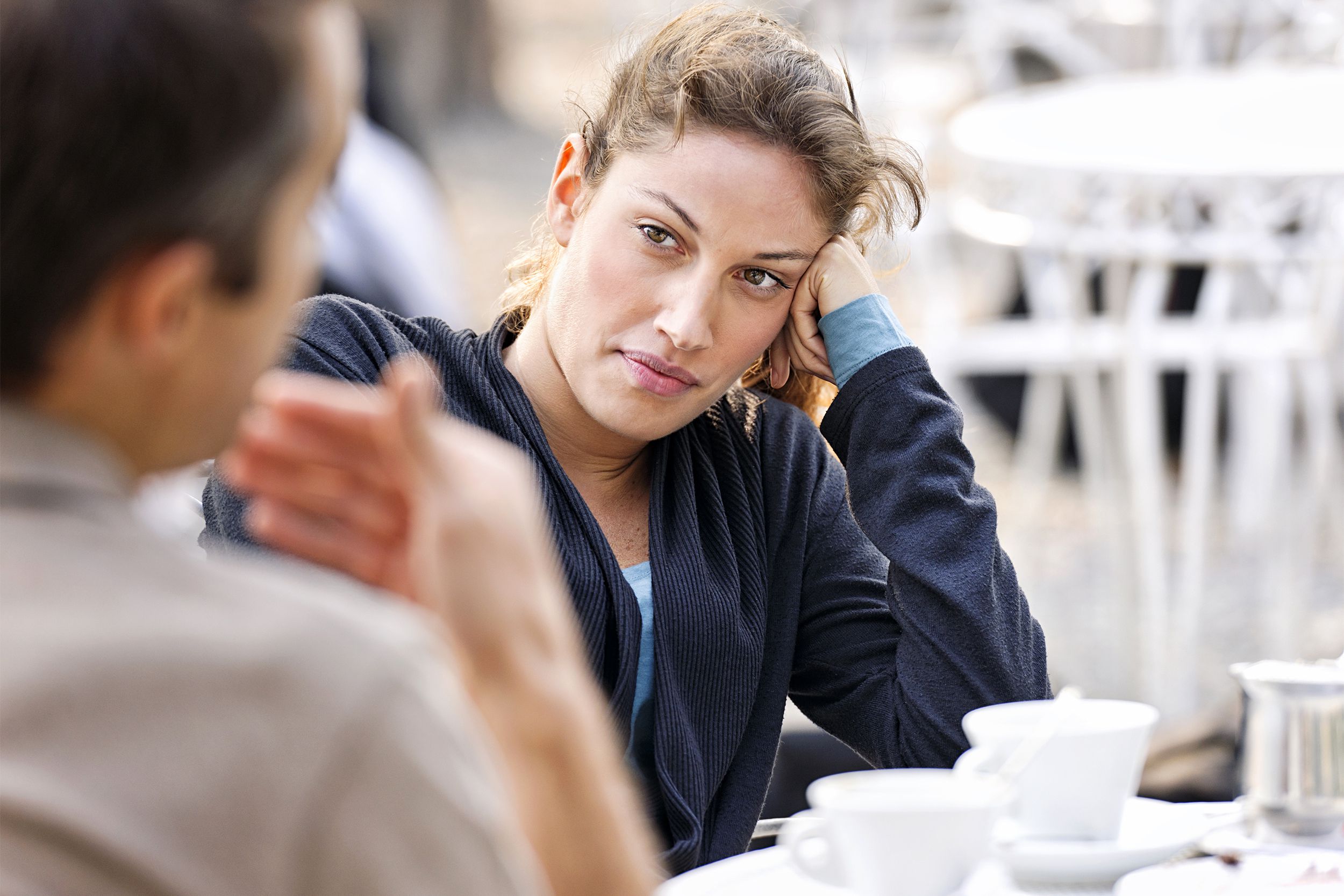 Woman looking bored listening to a man speak
