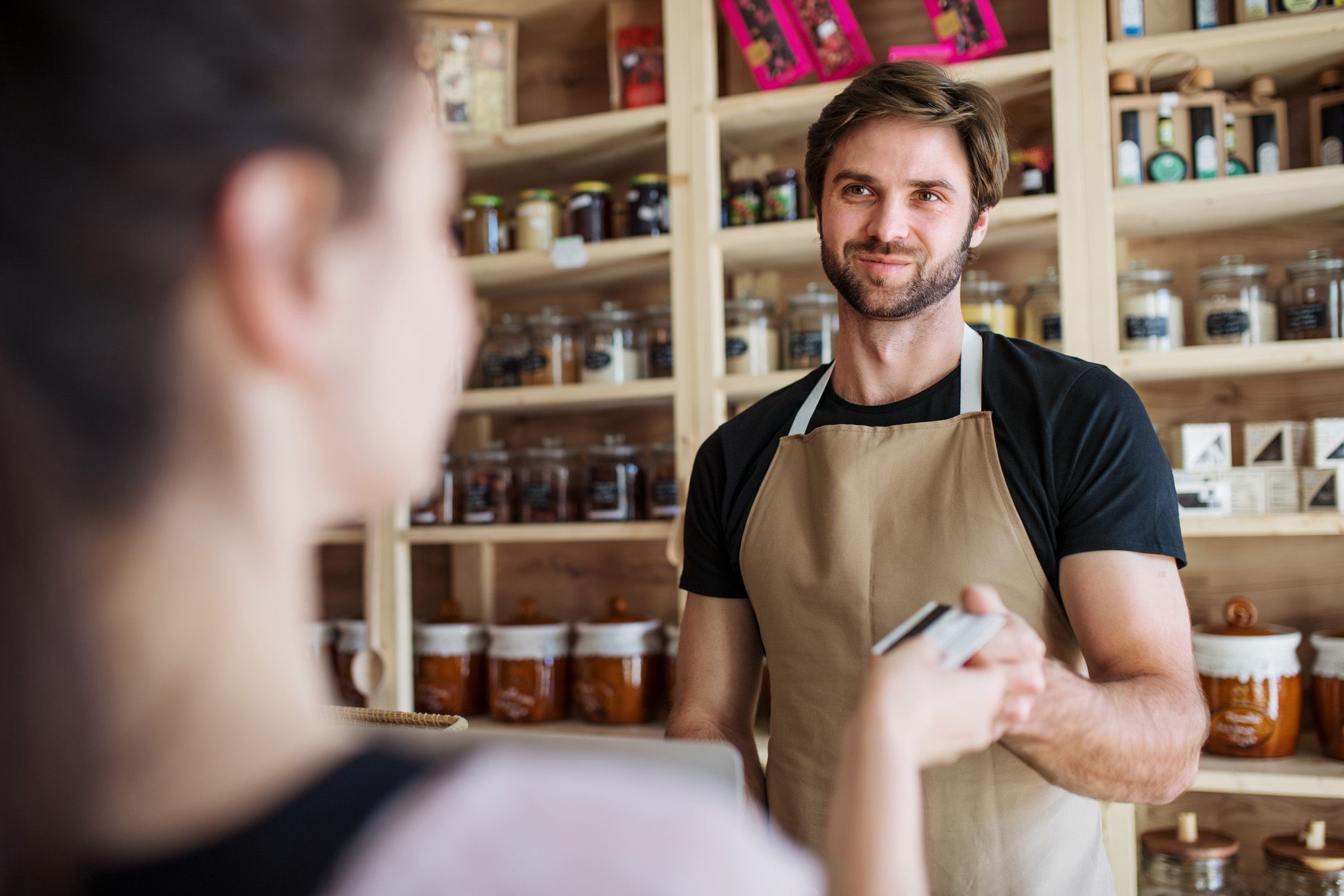 barista handing card to customer