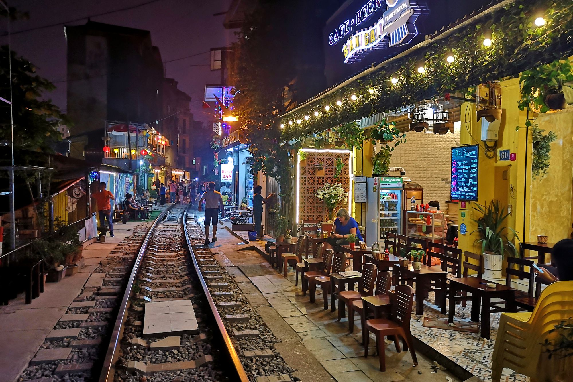 People along the famous railway track through Hanoi old quarter, the so-called Hanoi Train street, located between Lê Duẩn and Khâm Thin street