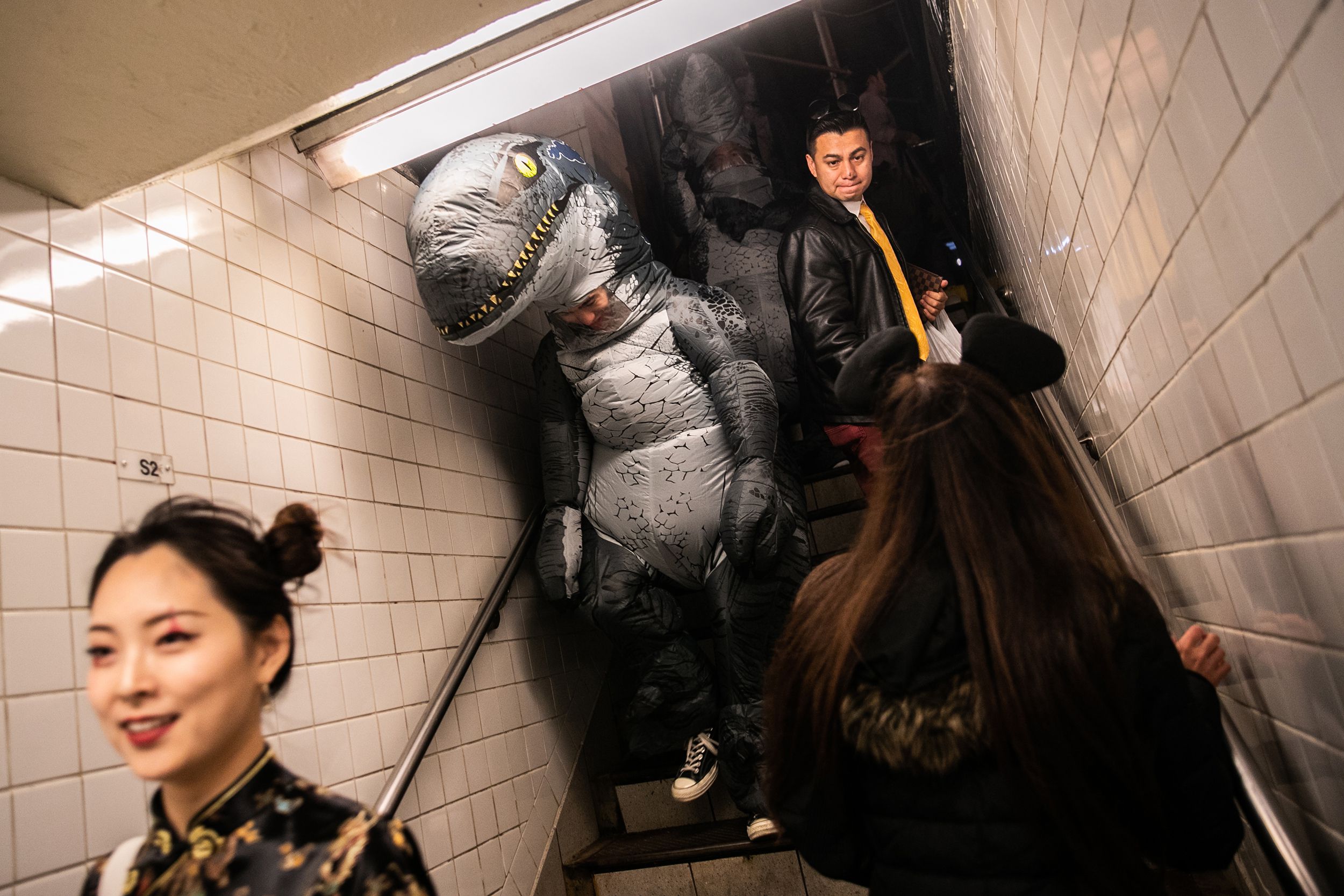 People wearing a costume get into a subway station on Halloween, October 31, 2019 in New York City
