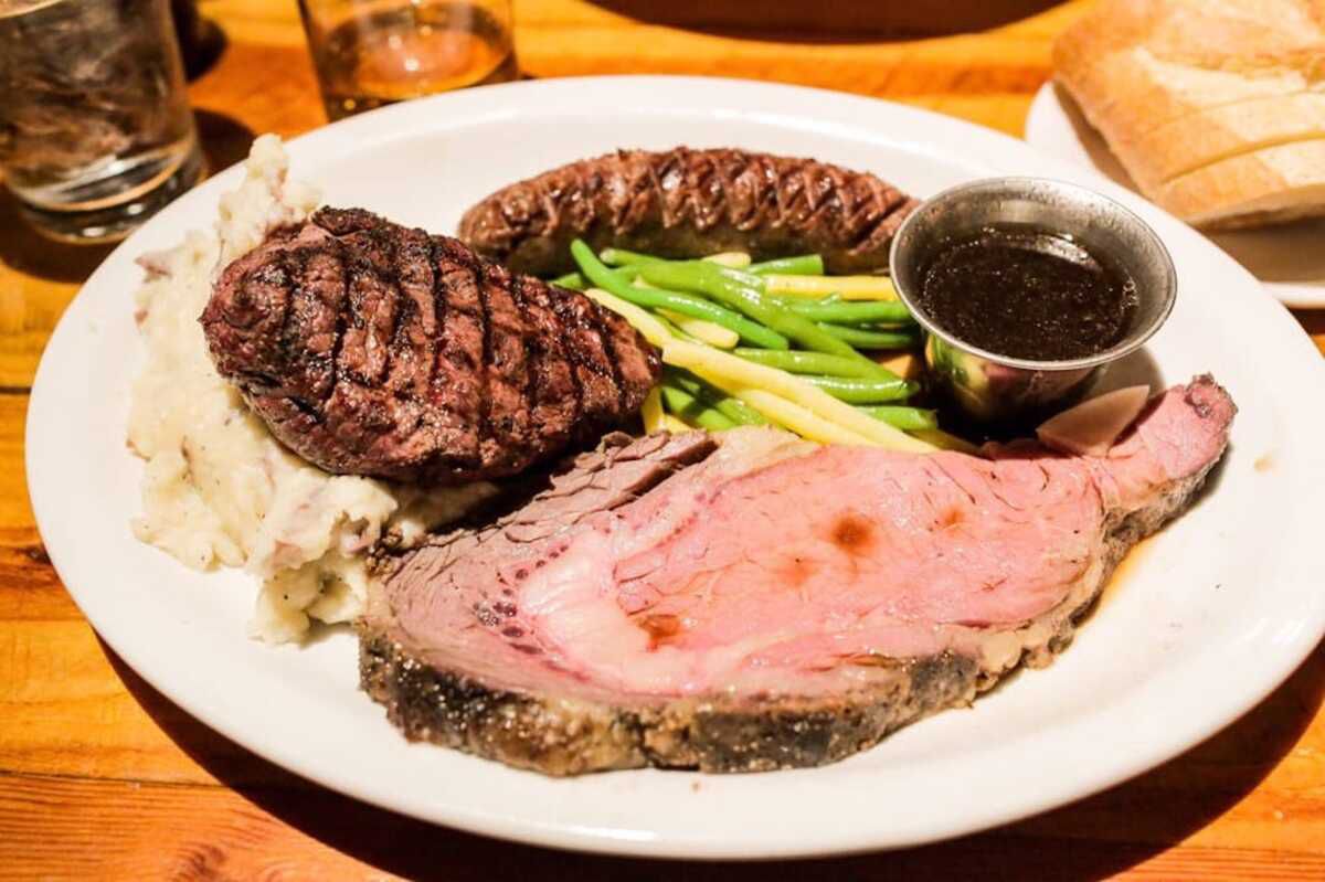 selection of game meat on plate with mashed potatoes at Gun Barrel, Jackson, Wyoming